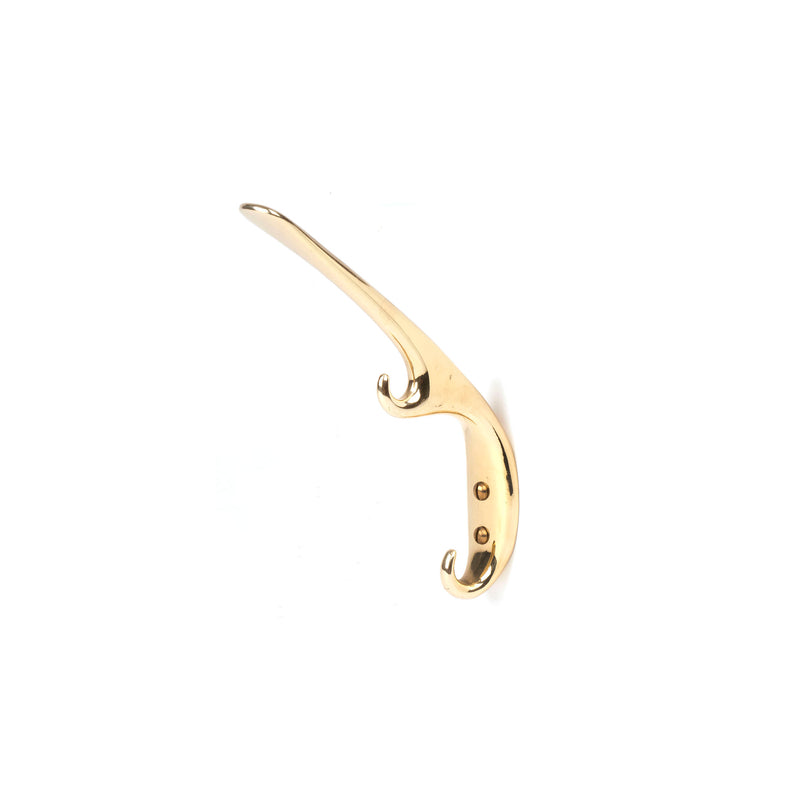 The Set of 3 Hooks #5439 by Werkstätte Carl Auböck, is a stylish brass wall hook with two screw holes for secure mounting. Its smooth, curved design features dual prongs, adding sophistication and elegance, perfect for hanging various items.
