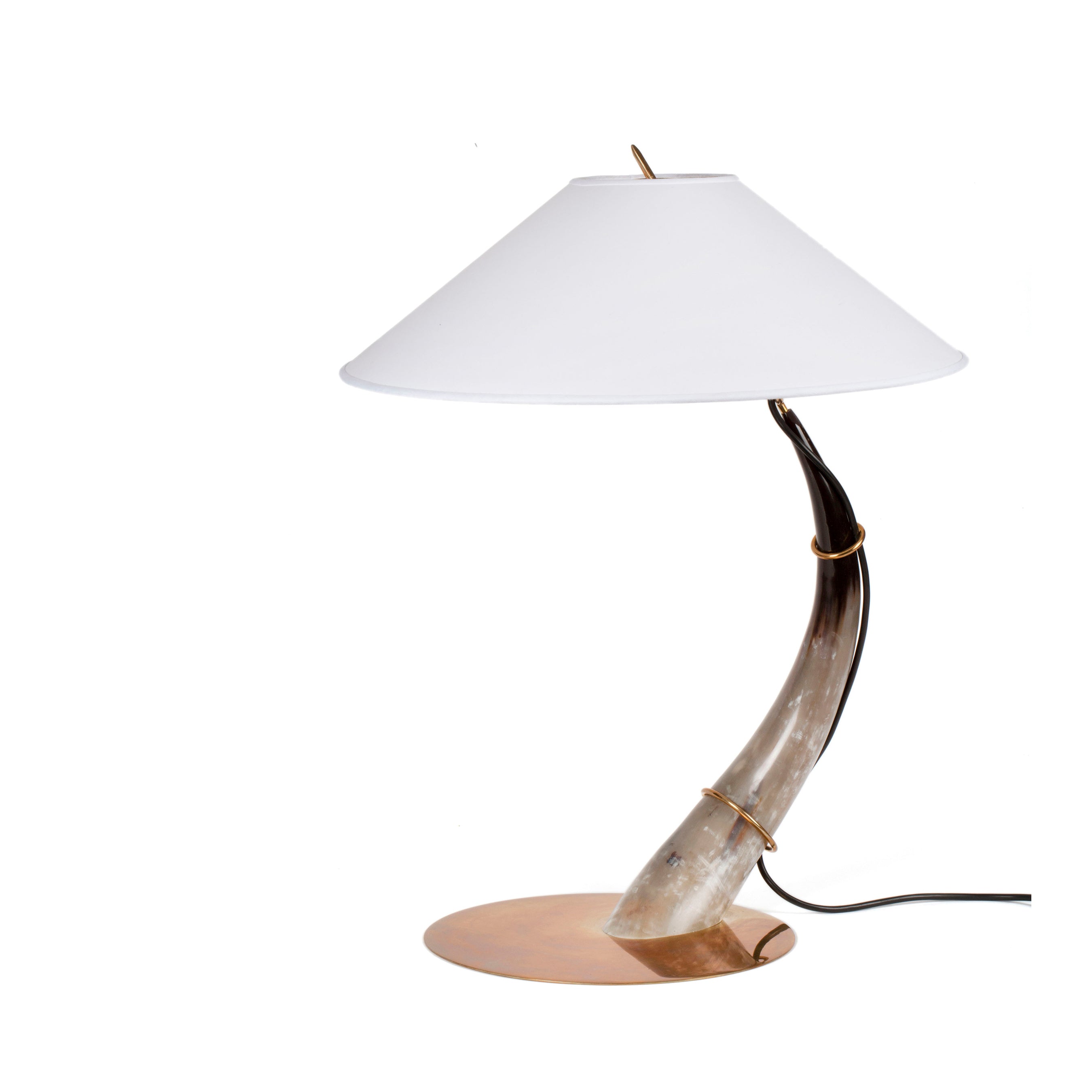 The Werkstätte Carl Auböck Table Lamp Horn #7255 has a base resembling a curved horn like Wiener Bronzen, with a round bronze stand, a wide white conical shade, and a black power cord.