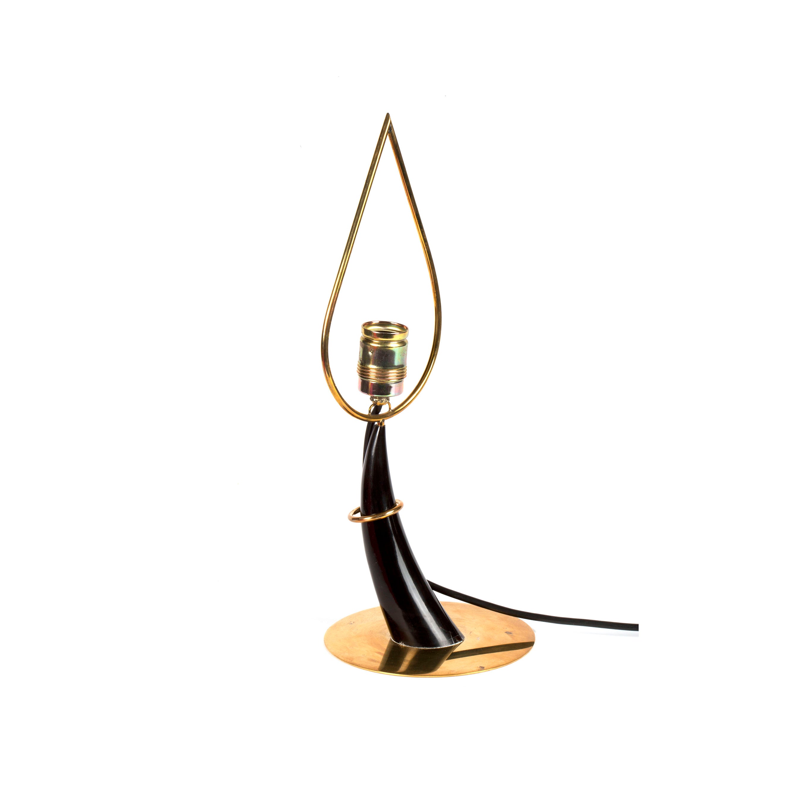 The Table Lamp Horn #7255 from Werkstätte Carl Auböck is a modern piece with a teardrop-shaped gold frame on a curved black base and round gold platform. It has a single bulb holder and an elegant black power cord extending stylishly from the base.