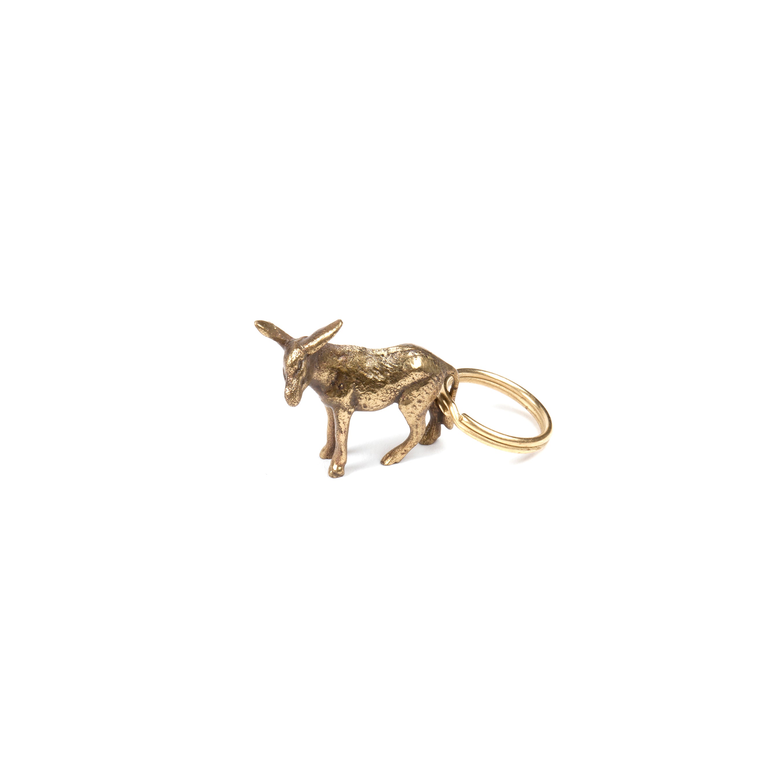 The Keyring Donkey #5608 by Werkstätte Carl Auböck is a small brass figure designed as a charming keychain, featuring a ring on its back. Against a plain white background, it reflects the timeless charm of Wiener Bronzen artistry.