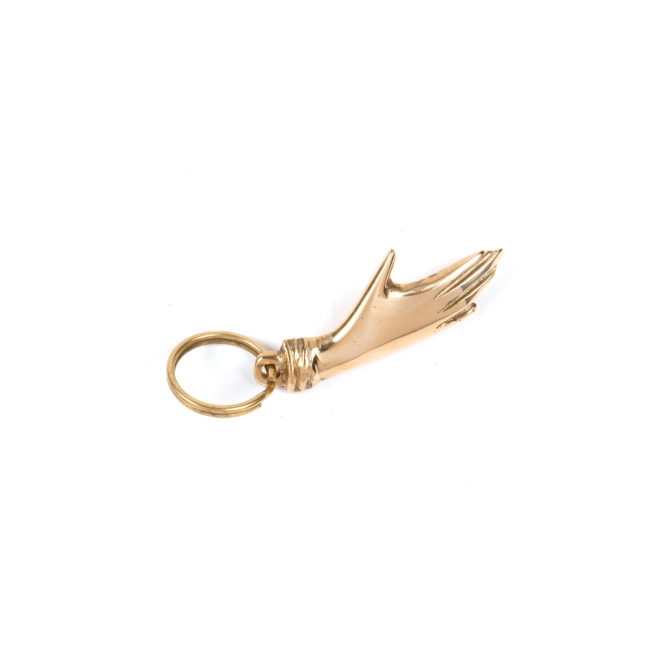 The Keyring Hand #5734 by Werkstätte Carl Auböck is a gold keychain with a hand-shaped charm and wrist loop for keys, elegantly blending functionality and inspired by Auböcks iconic Viennese brass designs.