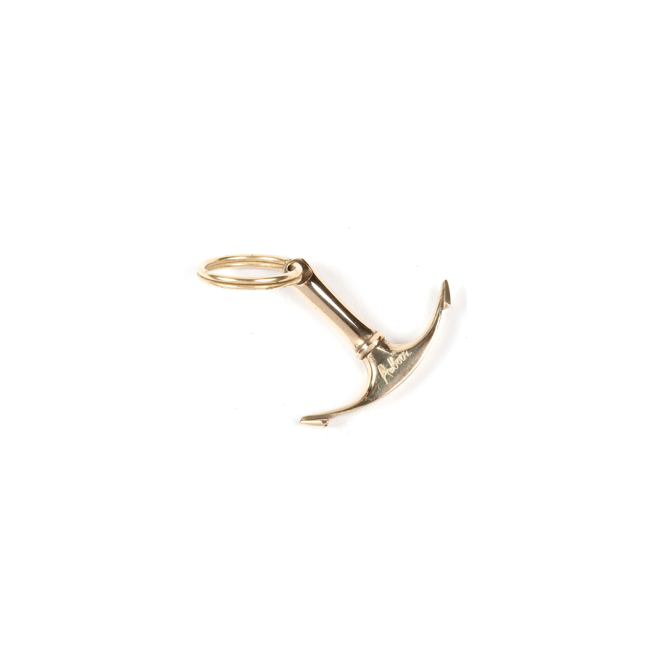 The Keyring Anchor #7151 by Werkstätte Carl Auböck is a gold keyring shaped like a boat anchor, showcased against a white background.