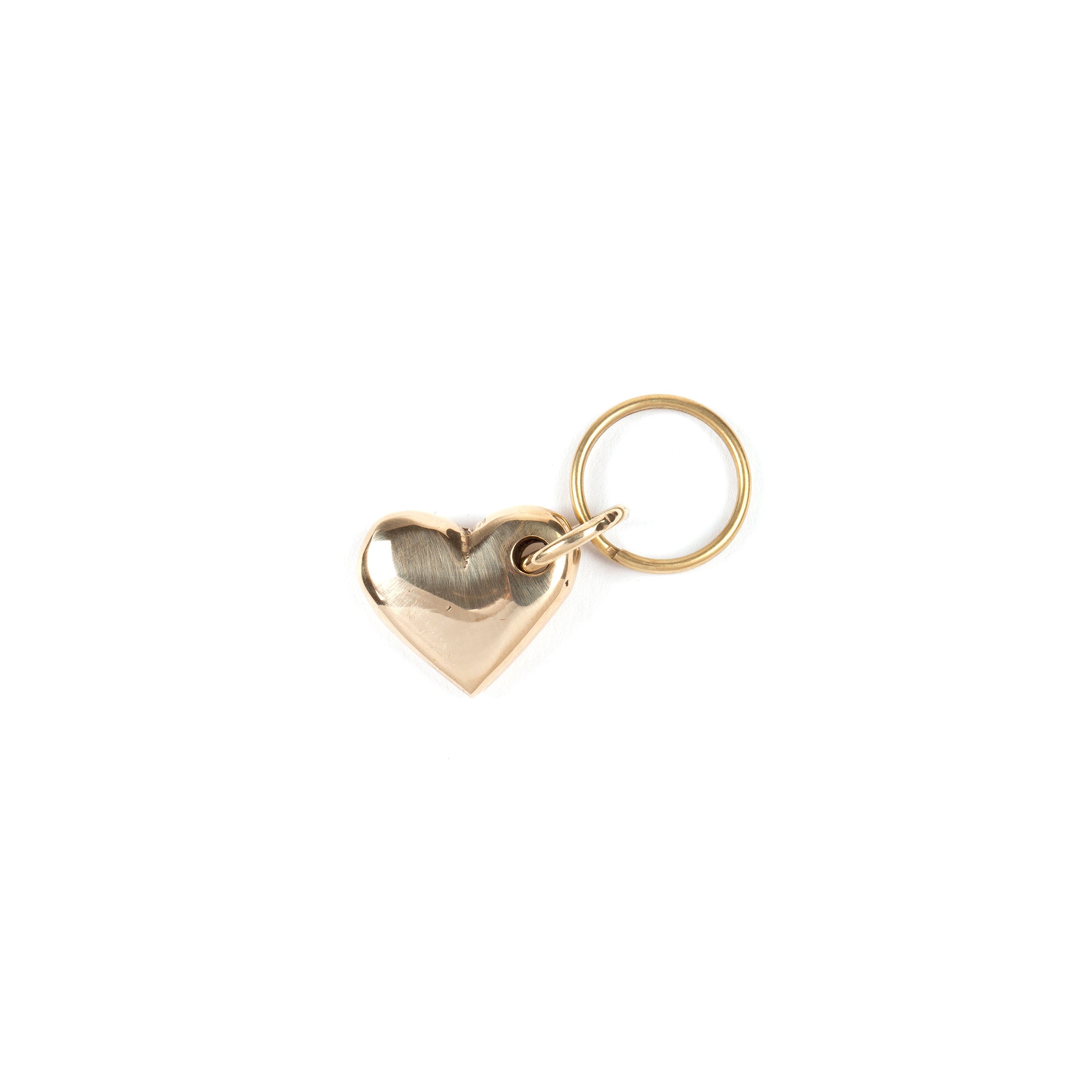 The Werkstätte Carl Auböck Keyring Heart #5600 features a smooth, shiny gold heart-shaped keychain attached to a round keyring, set against a plain white background.