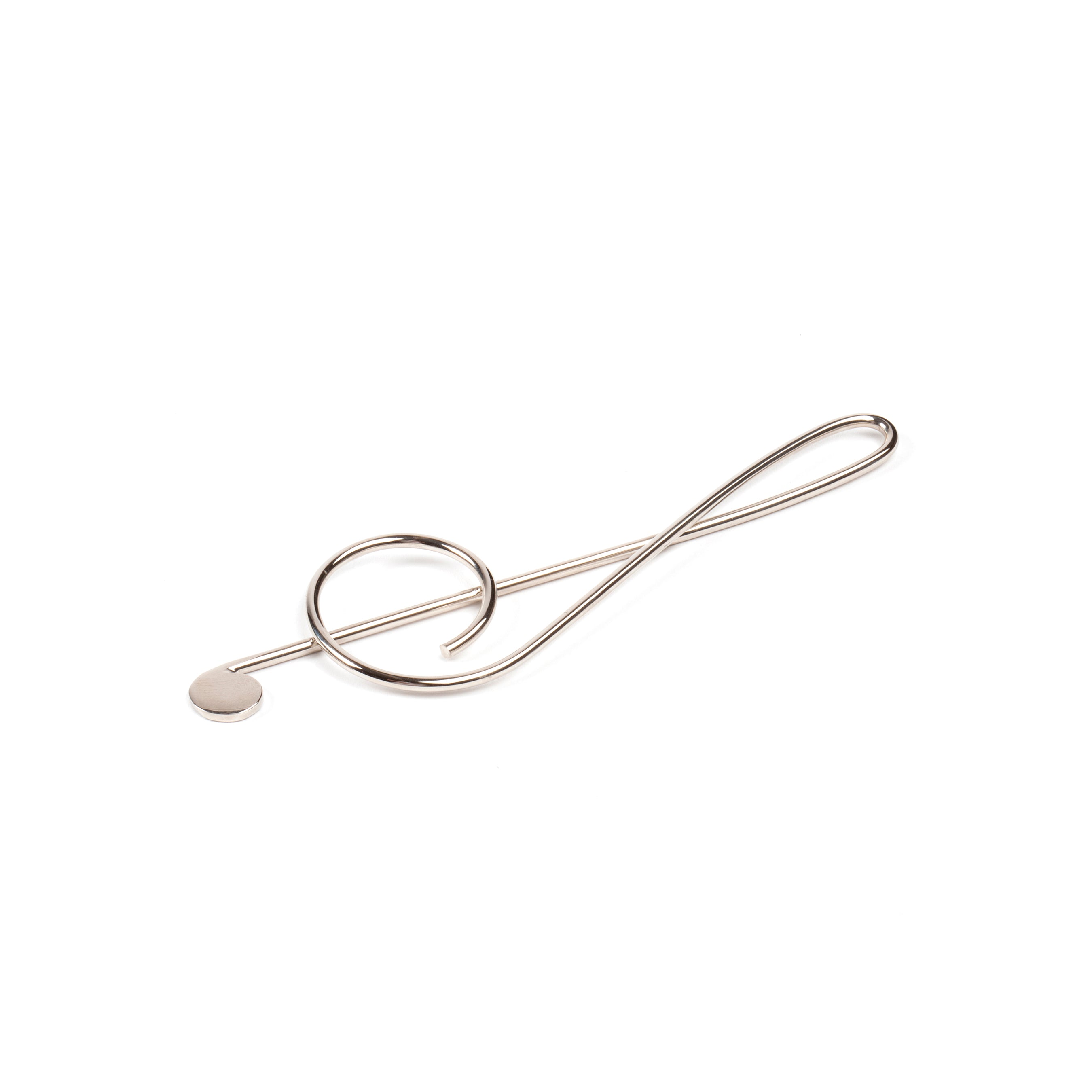 The Werkstätte Carl Auböck Paper Clip Musical Clef #4740 is a silver wire sculpture stylishly shaped like a treble clef symbol, captured on a pristine white background.