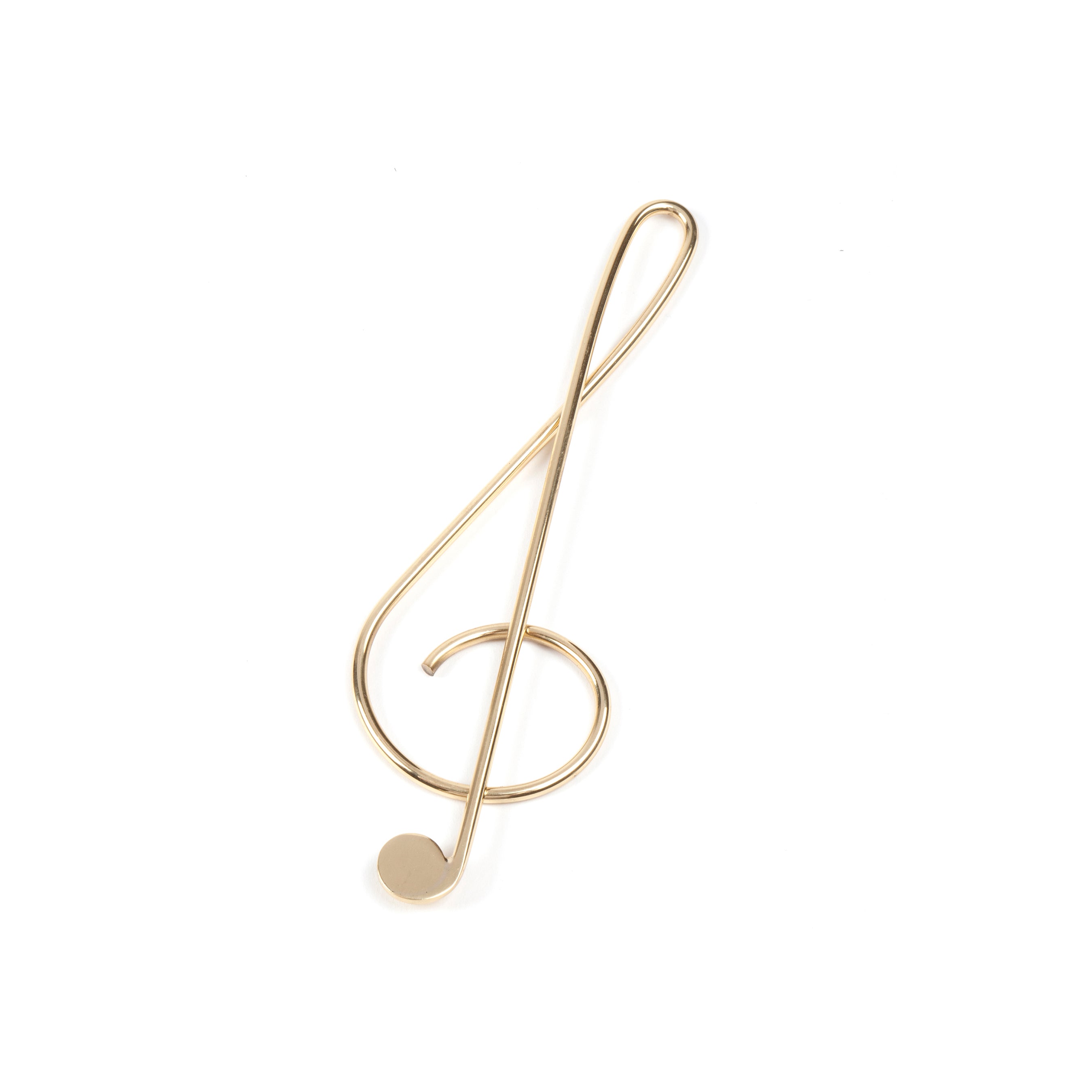 The Paper Clip Musical Clef #4740 from Werkstätte Carl Auböck features a brass treble clef symbol on a pristine white background, echoing the elegant designs inspired by Wiener Bronzen.