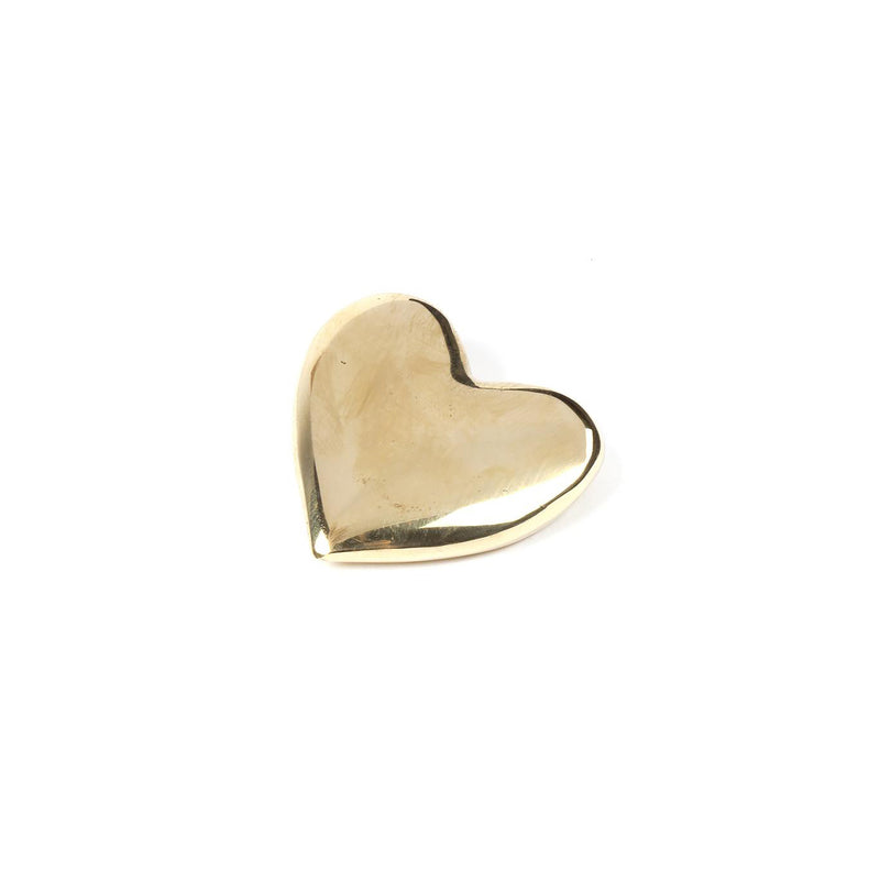 The Paperweight Heart #5371 by Werkstätte Carl Auböck, a small shiny gold heart-shaped piece, evokes the exquisite craftsmanship of a Viennese townhouse and sits elegantly against a plain white background.