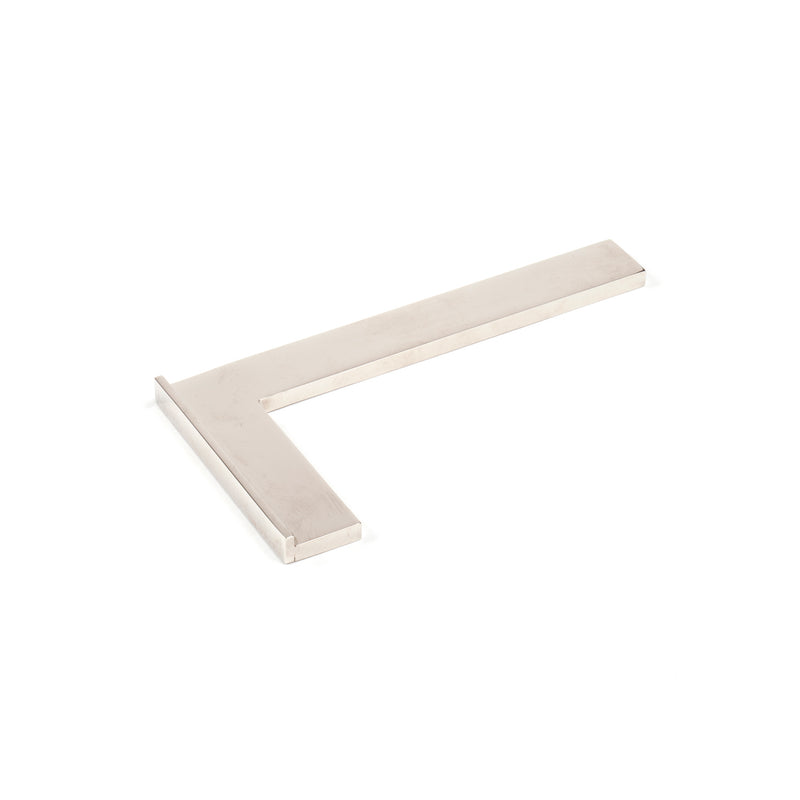 The Werkstätte Carl Auböck Paperweight Square #4948 features a metal right-angle design for measuring or drawing precise 90-degree angles, akin to the precision of Carl Auböck designs, elegantly displayed against a plain white background.