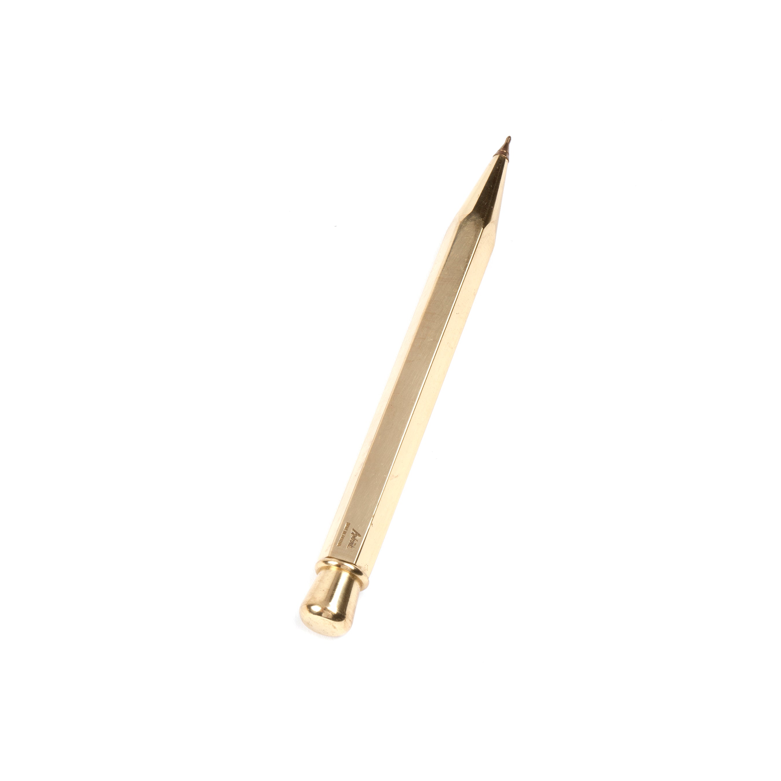 The Werkstätte Carl Auböck Ball Point #5037 is a gold-colored mechanical pencil with a hexagonal body and pointed tip, displayed elegantly on a white background.