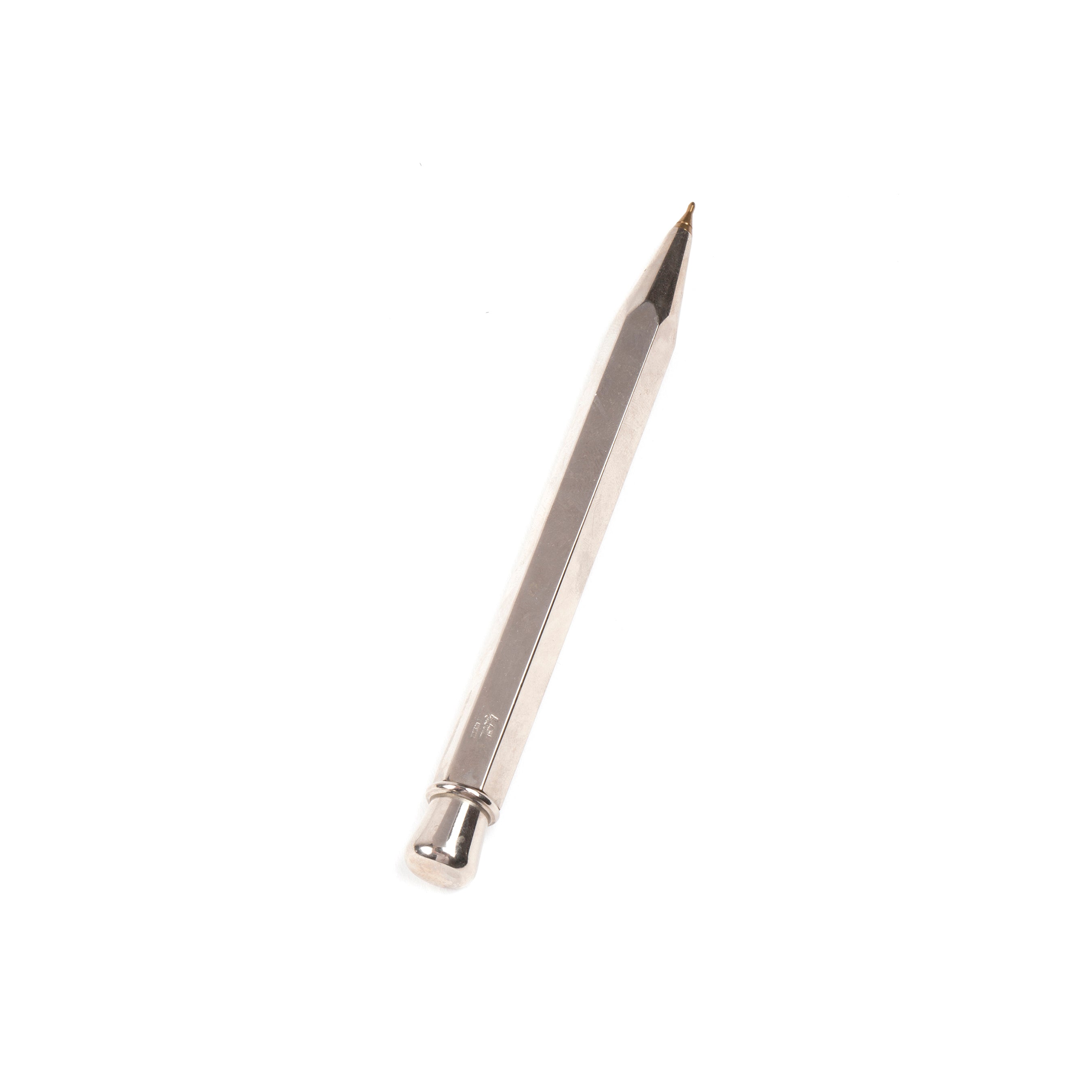 The Ball Point #5037 by Werkstätte Carl Auböck is a sleek, metallic mechanical pencil with a hexagonal body and pointed tip, echoing the refined artistry of Carl Auböcks Viennese workshop, pictured against a white background.