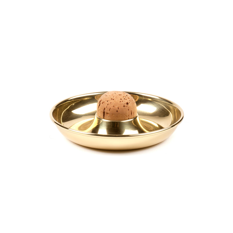 The gold-colored Pipe Ashtray #7201 by Werkstätte Carl Auböck embodies Viennese design, featuring a metallic sheen and a central section with an organic texture reminiscent of cork or stone, reflecting Carl Auböcks sophisticated minimalistic aesthetic.