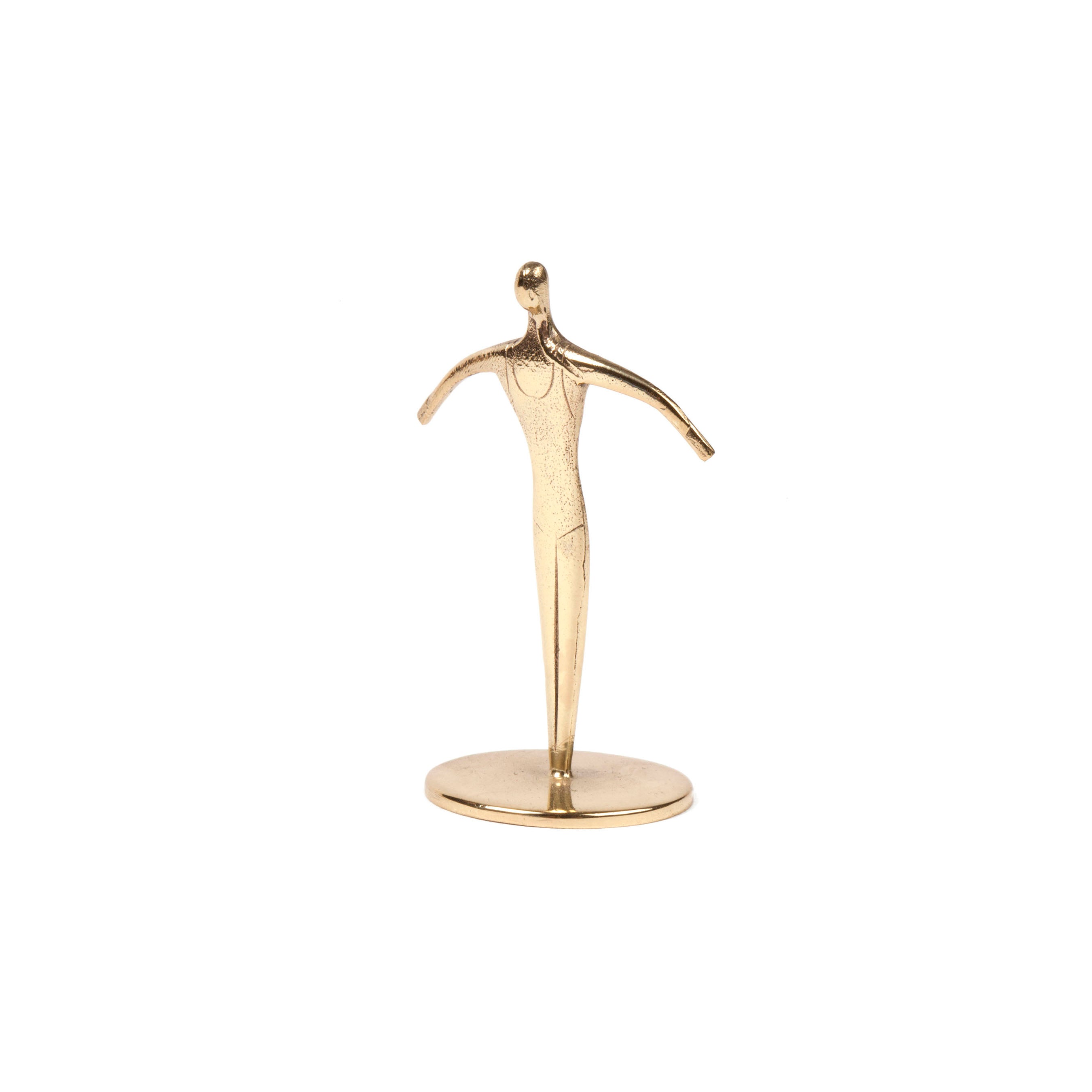 Sculpture Sportsman #7204 by Werkstätte Carl Auböck is an elegant golden piece on a round base, featuring a sleek, minimalist figure with outstretched arms in the style of the famed Viennese workshop.