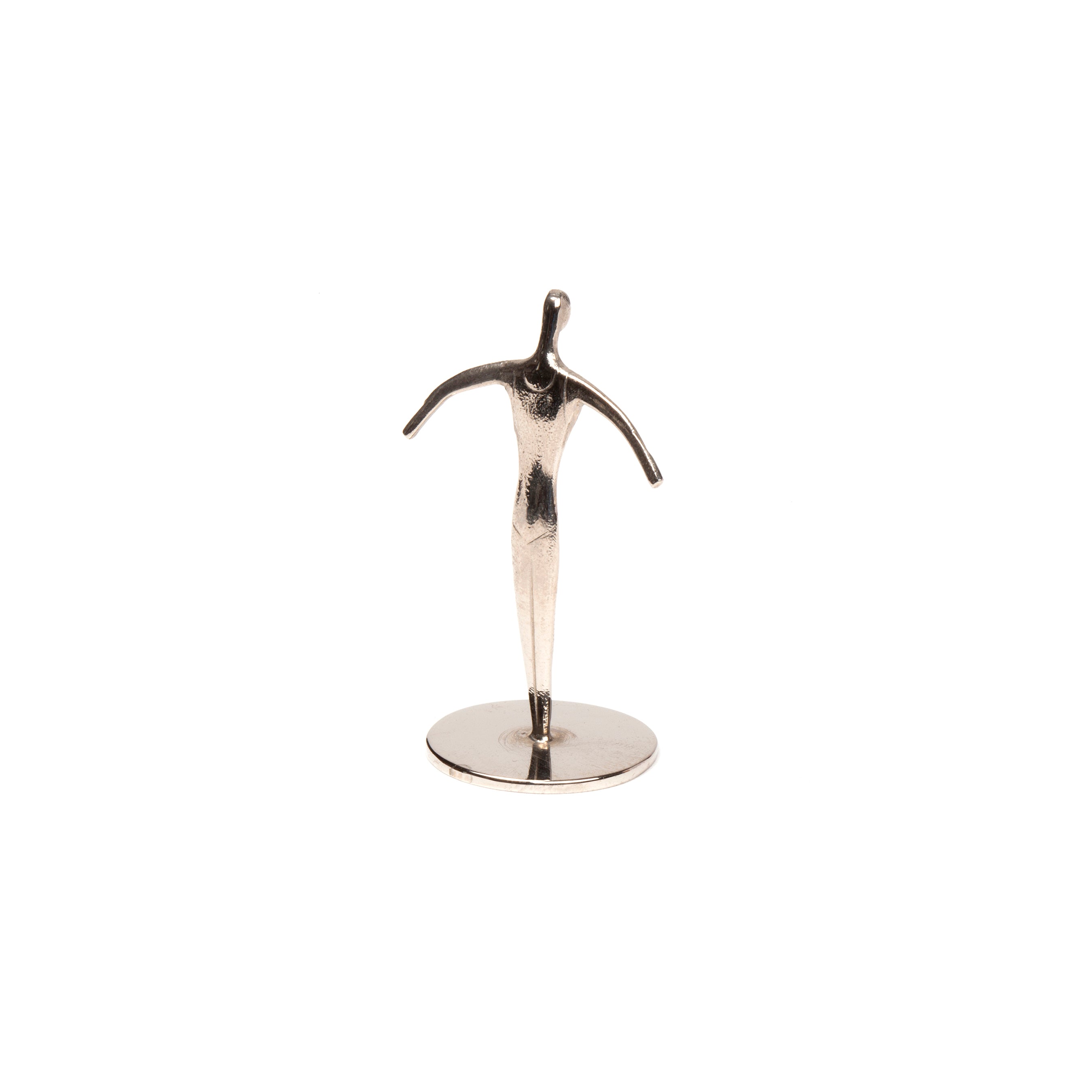 Sculpture Sportsman #7204, by Werkstätte Carl Auböck, is a minimalist silver human figure with outstretched arms in the Viennese workshop style, positioned on a round base against a plain white background.