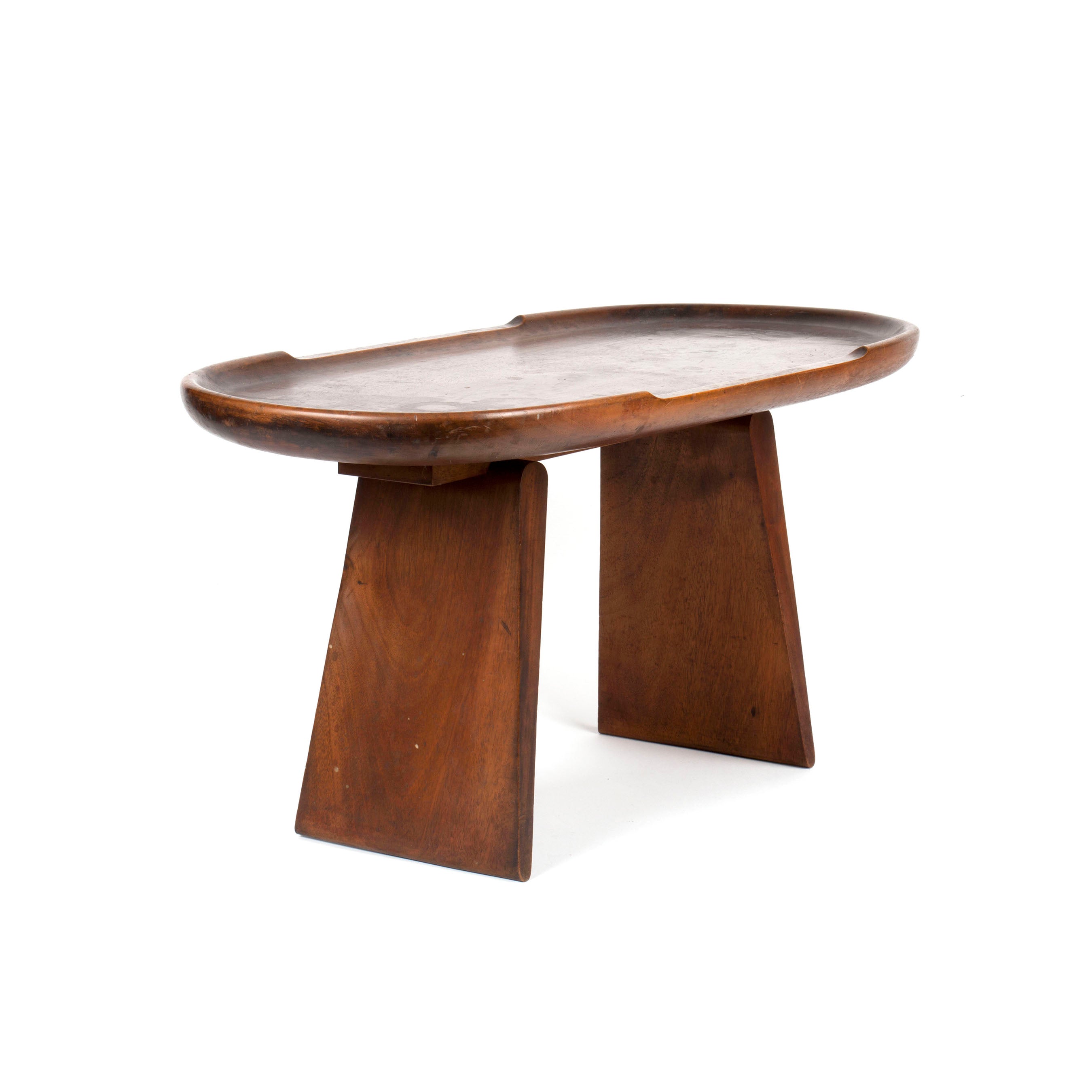 Werkstätte Carl Auböcks Table #3511 features an oval top and two wide, angled legs. Its smooth surface with slightly raised edges and rich brown finish highlight its modern minimalist appeal.