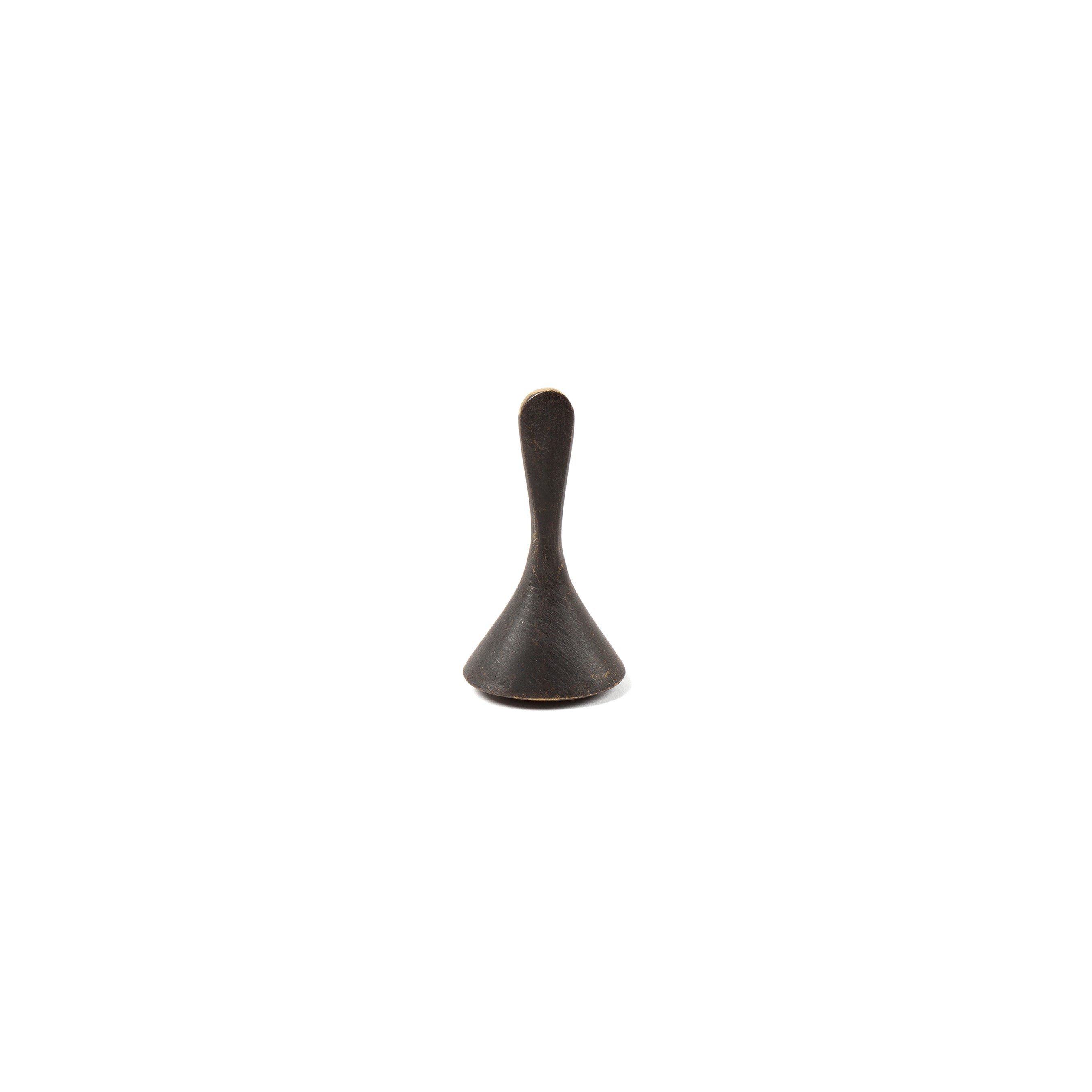 A small, metallic cone-shaped object with a narrow, rounded handle on top resembling a spinning top by Werkstätte Carl Auböck is centered on a plain white background. It is the Snuffer #4117A.