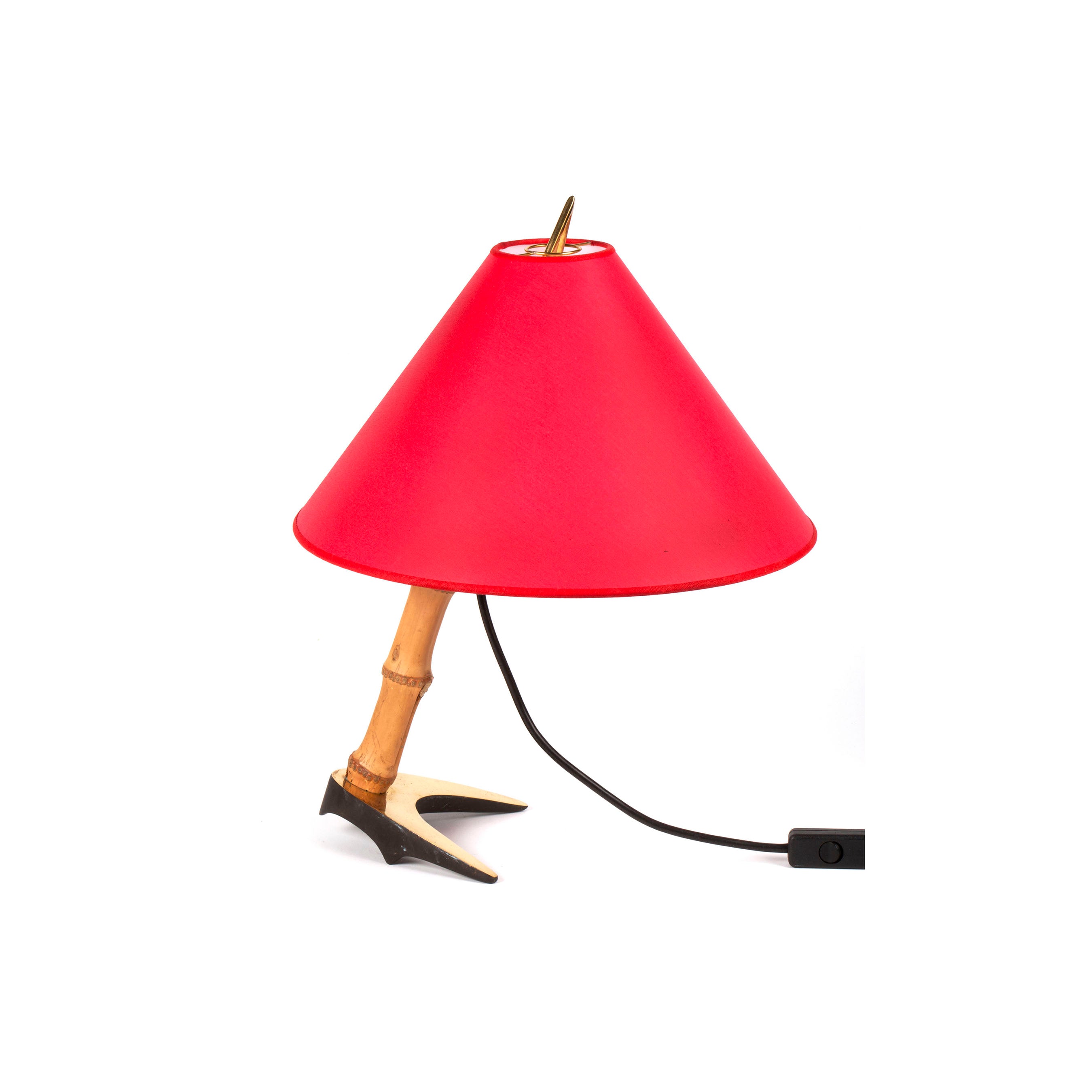 The Table Lamp Horse Shoe #3741 by Werkstätte Carl Auböck features a red cone-shaped shade atop a birds leg-inspired stand with talons, reminiscent of Auböcks designs. It has a Viennese workshop vibe and includes a black power cord extending from its unique base.