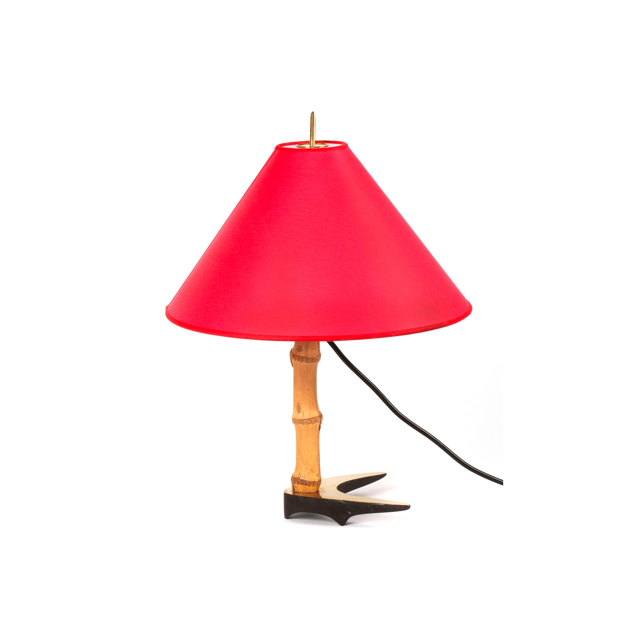 The Table Lamp Horse Shoe #3741 by Werkstätte Carl Auböck features a red cone-shaped shade, bamboo-style base, anchor-shaped support, and visible black power cord; it stands on a white background reminiscent of a Viennese workshop.