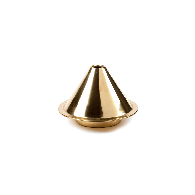A brass Vase Cone #7144 from Werkstätte Carl Auböck sits on a white surface. Its shiny, conical form features highlights from the overhead lighting, akin to other famed Carl Auböck pieces. The elegant vase has a wide base and tapers to a small top opening.