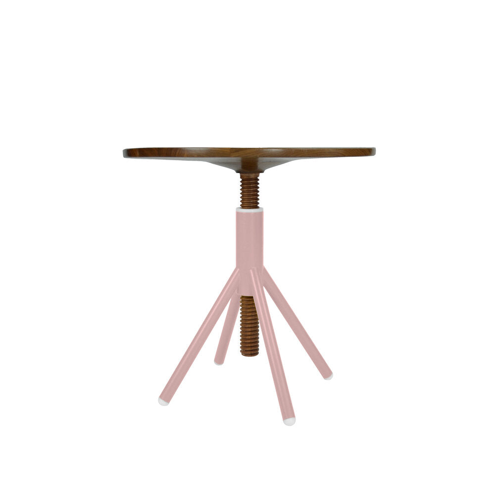 The Thread Family - Bistro Table by Coordination Berlin is a fusion of industrial and minimalist styles. It features a round walnut wooden top with an adjustable pink screw mechanism, supported by three pink metal legs and a welded steel base.