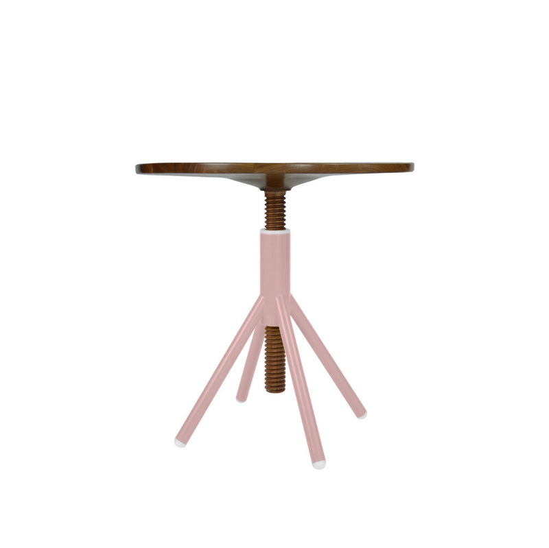 The Thread Family - Bistro Table by Coordination Berlin is a fusion of industrial and minimalist styles. It features a round walnut wooden top with an adjustable pink screw mechanism, supported by three pink metal legs and a welded steel base.