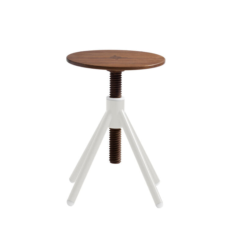The Thread Family Stool by Coordination Berlin is a modern, height-adjustable piece featuring a round walnut wood seat and a white metal base with three angled legs, connected by a visible screw mechanism to the welded steel base.