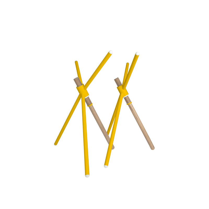 Thread X by Coordination Berlin is a stylish design featuring three yellow pencils with erasers intersecting in a contemporary tripod form, exposing their natural wooden interiors against a plain white background, echoing the style of height-adjustable furniture.