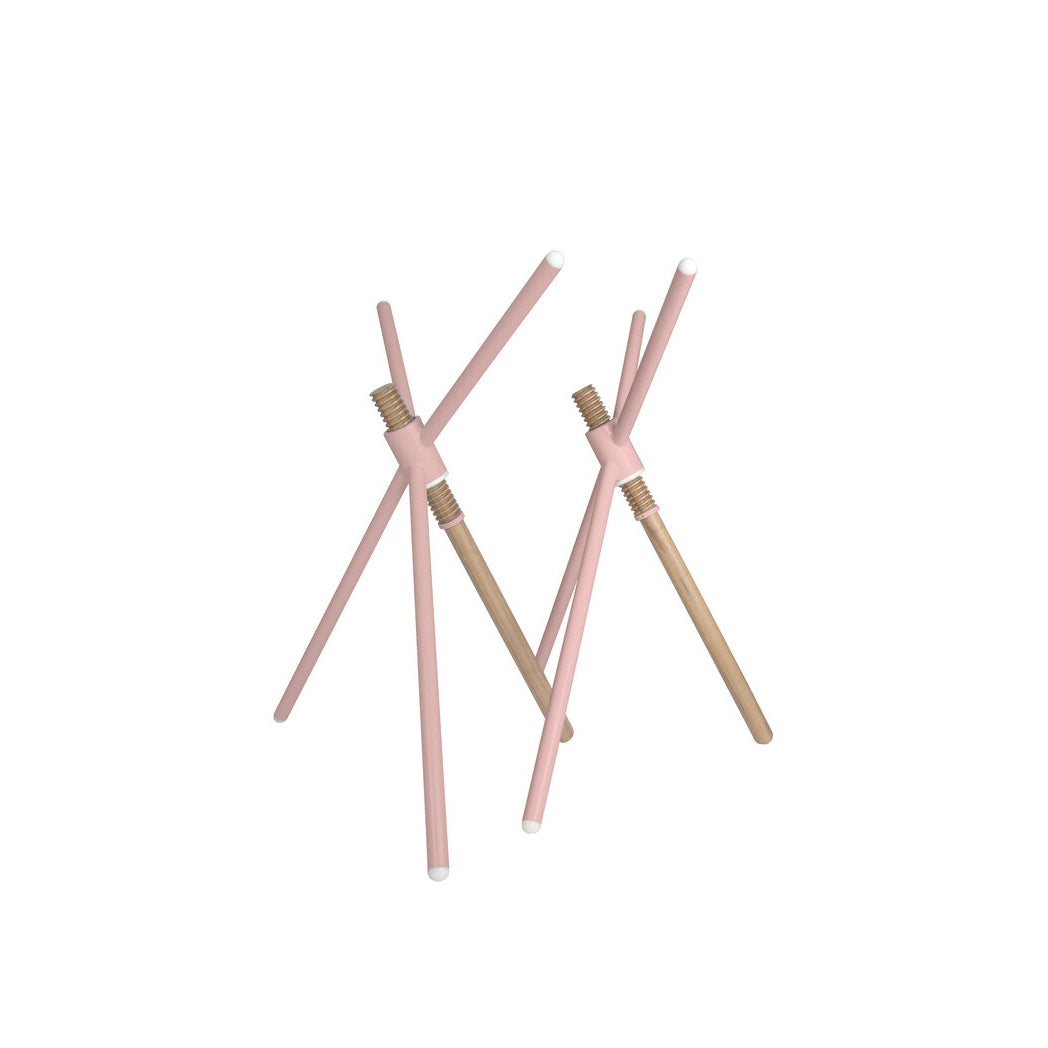 The abstract sculpture from Coordination Berlin has wooden rods in a natural wood and light pink finish, intersecting vertically against a white background. It captures the essence of contemporary design akin to their Thread X masterpiece, merging artistry with architectural elegance.