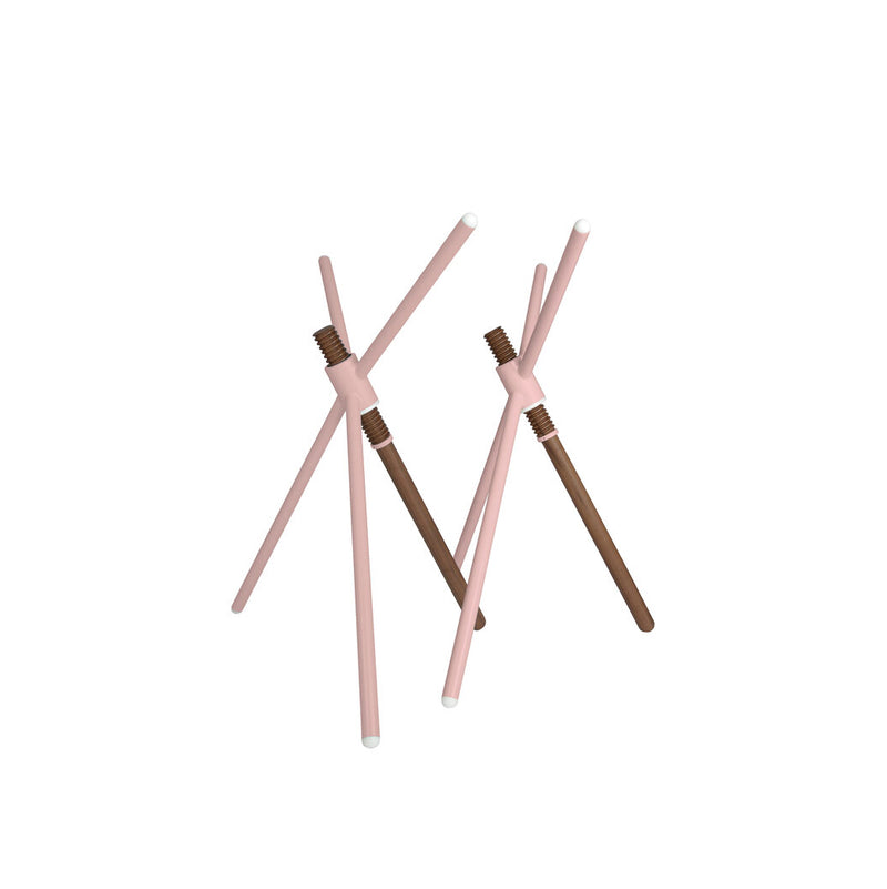 The Thread X sculpture by Coordination Berlin features minimalist intersecting pink and brown cylindrical rods with white tips on a white background, arranged in a geometric angular pattern that highlights contemporary design and innovative artistry.