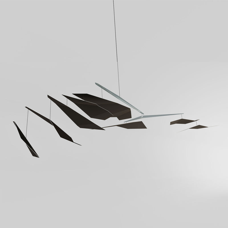The Crowd mobile by Coordination Berlin, designed by Flip Sellin, showcases a modern minimalist design with geometric black and gray shapes. Suspended against a white background, it evokes contemporary architecture with an abstract and balanced composition.
