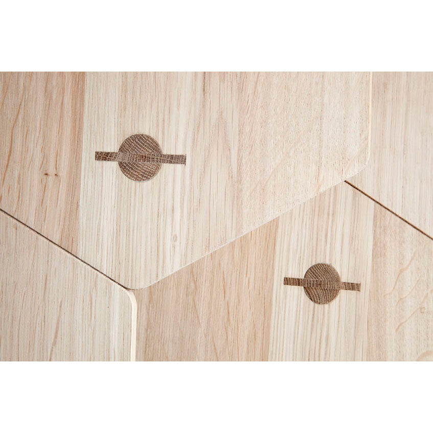 Close-up of a light wooden surface crafted from local oak, featuring geometric patterns with circular and linear inlays. The pronounced wood grain enriches the contemporary design, giving a seamless tiled look reminiscent of sleek Lean Tables by Coordination Berlin.