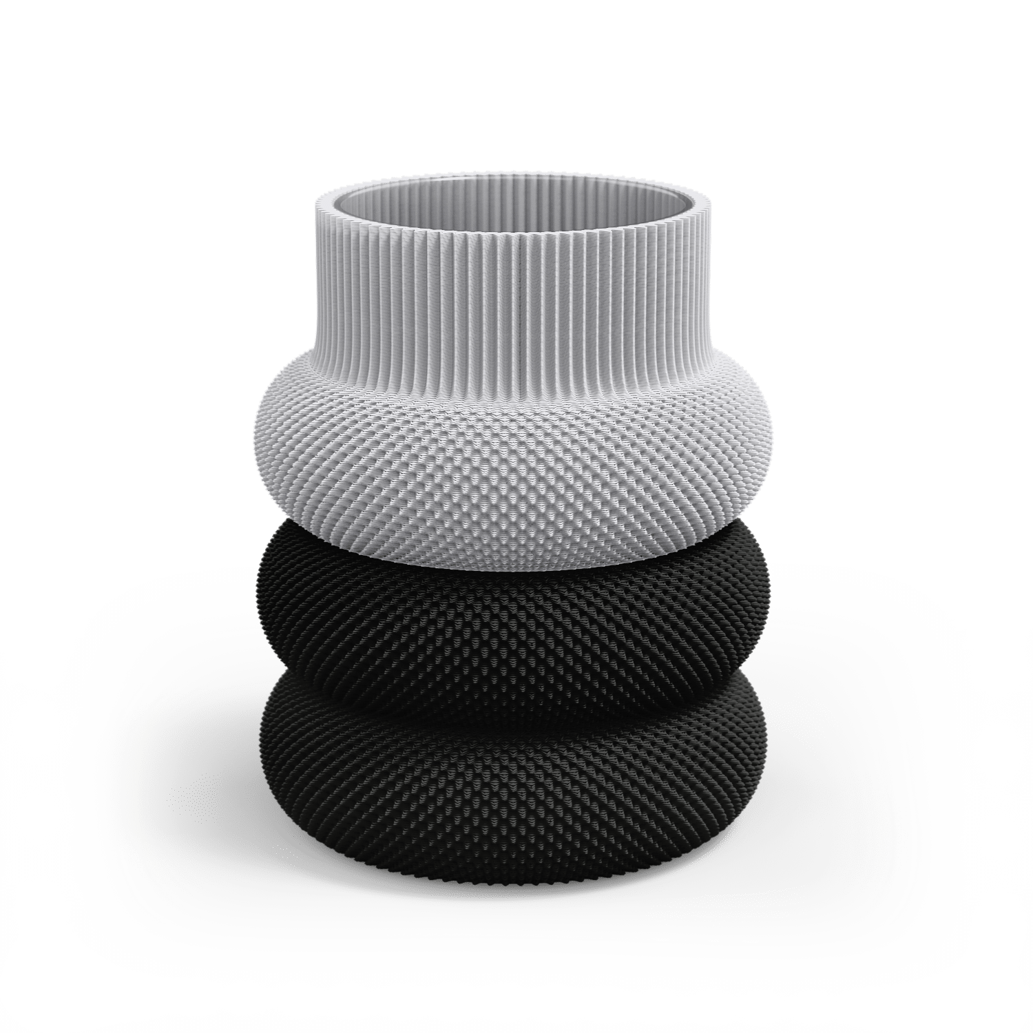 The Dorn 110g Vase by Sheyn is a modern, eco-friendly creation made via innovative 3D printing. It features a white, ribbed top and two sleek black sections below, with a rounded stacked design that contrasts in color and texture while resting on a reflective surface.