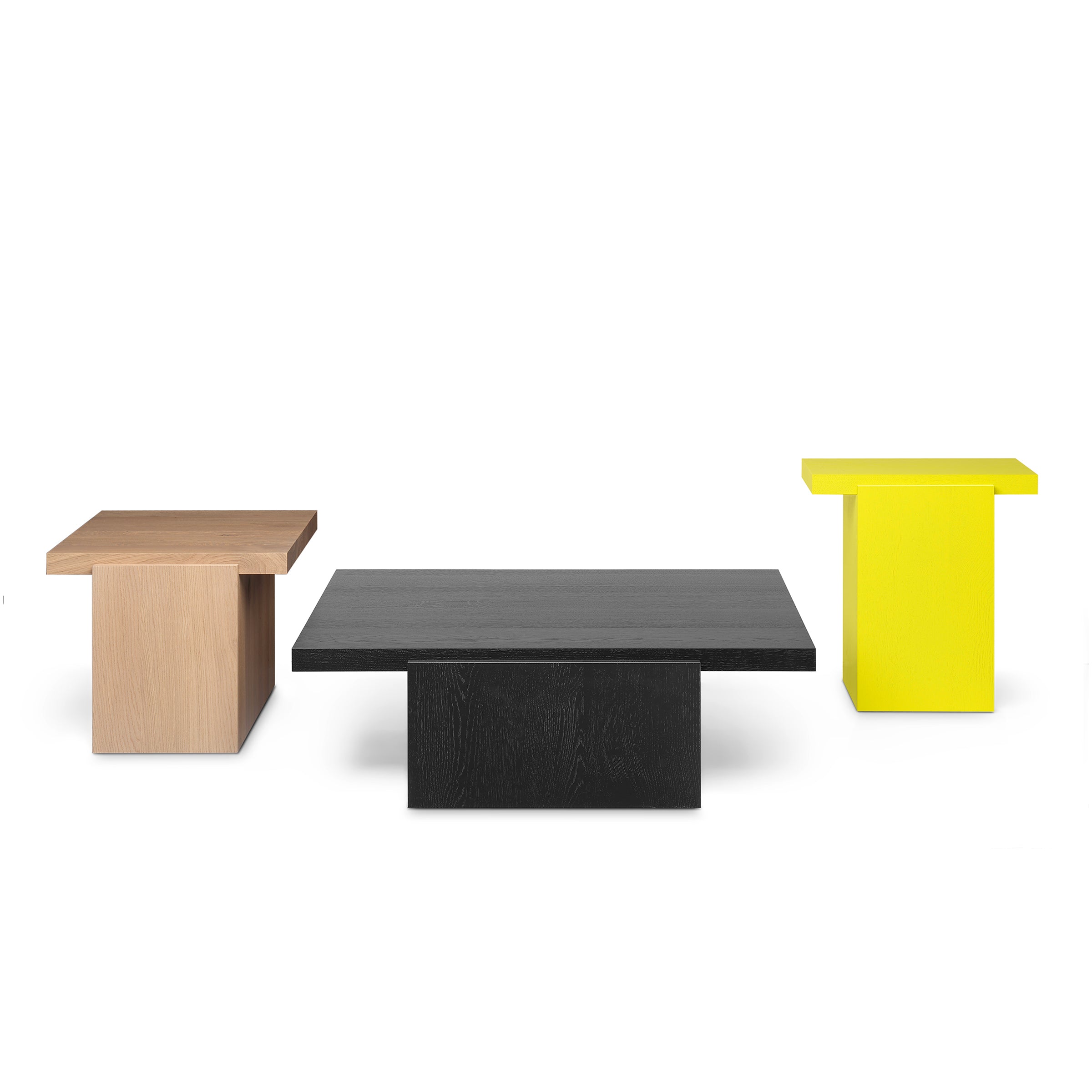 A set of three DT02 TORE side tables by E15 against a white background features minimalist design: the left in light wood, the center in black, and the right in vibrant yellow. Each table has a rectangular top and solid base for elegance.