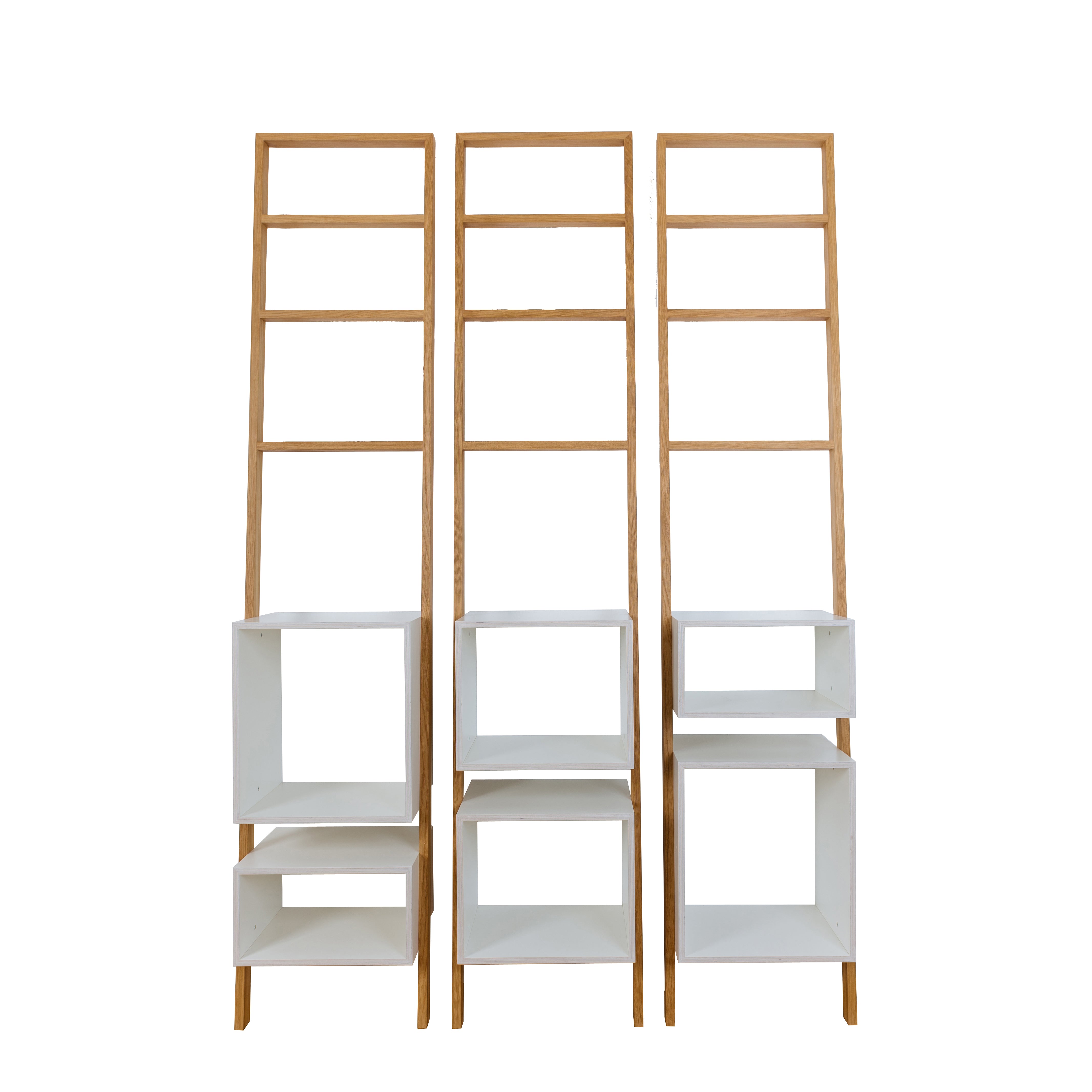 The Brecht shelving by Das kleine b features three tall wooden ladder-style shelves, each with white square units at the bottom, creating a minimalist and space-saving furniture solution against a plain white background.