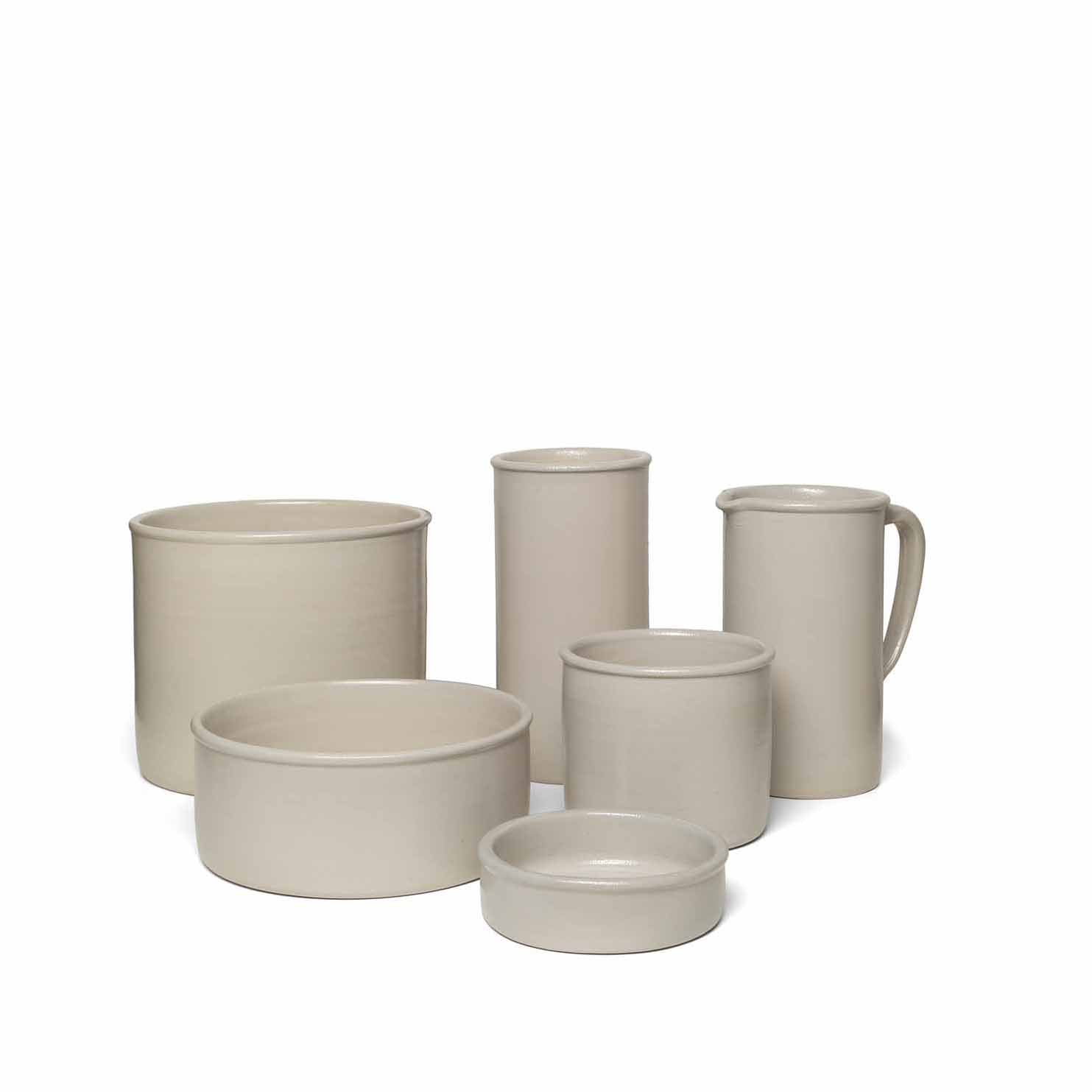 The AC19 SALINA collection by E15 features six beige stoneware containers, including bowls, jars, and a pitcher with varying sizes and shapes. Displayed on a white background, their modern design radiates the charm of handmade pottery.