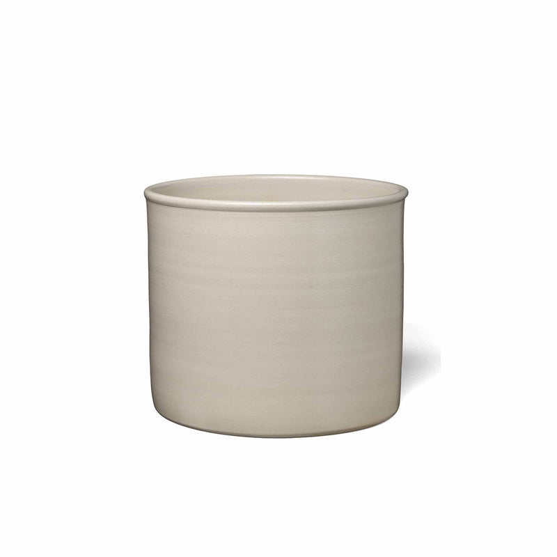 The AC19 SALINA by E15 is a cylindrical stoneware planter with a smooth beige finish against white. Its modern design showcases a slightly rounded rim and minimalist, handmade pottery-inspired style.