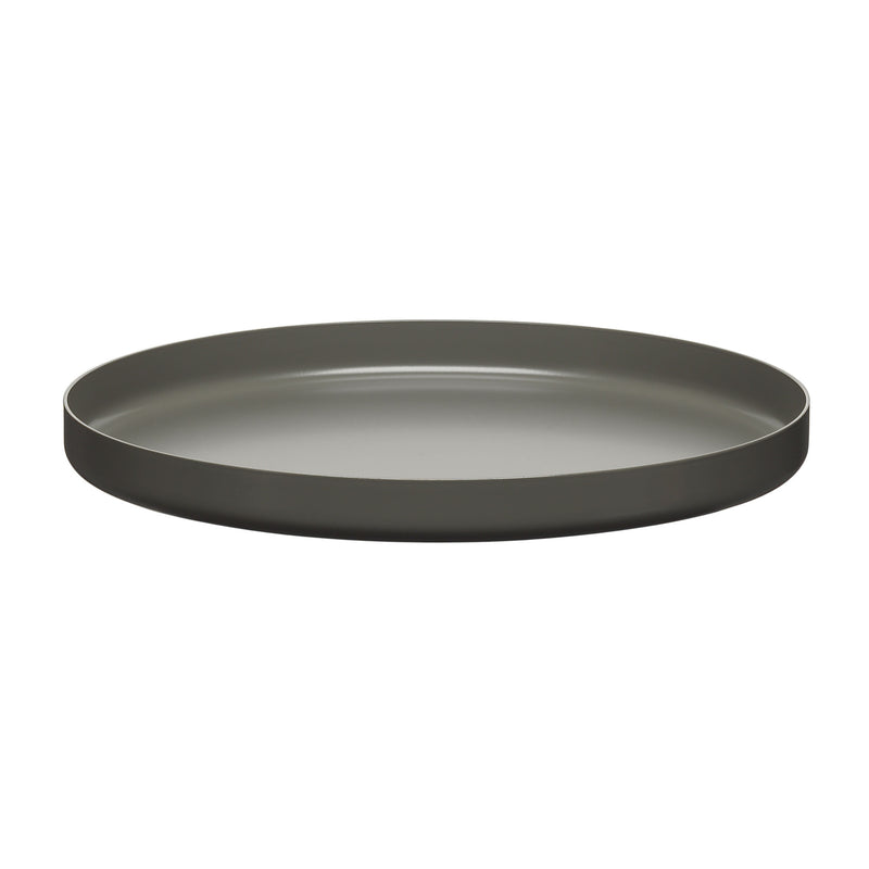 The CM05 HABIBI TRAY by E15 is a sleek, round metal tray in dark gray with a smooth, flat surface and slightly raised edges, casting a subtle shadow on a white background when viewed from an angle.