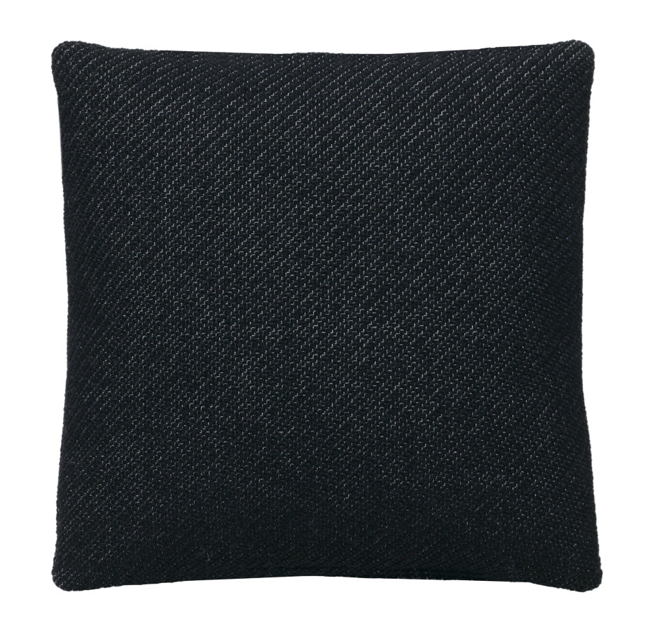 The E15 CU06 NIMA cushion features a square, textured black design with a subtle diagonal weave in fabric and leather. Its soft, plush material makes it a perfect addition for home decor or comfort, combining simplicity with elegance.