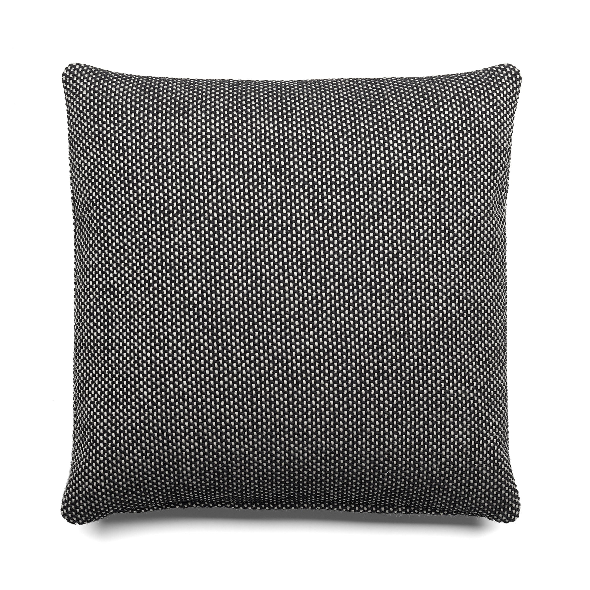The CU06 NIMA cushion by E15 showcases a square design with a black and white textured pattern on a white background, reflecting Farah Ebrahimis sophisticated touch.