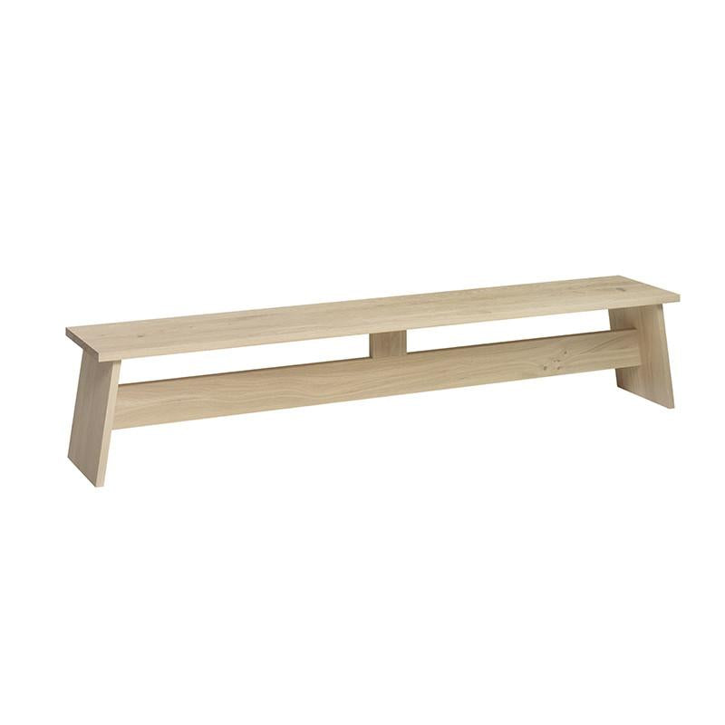 Discover the sleek DC02 FAWLEY bench by E15, crafted from solid wood with a light natural finish and an open space between its rectangular seat and slightly angled legs—an homage to David Chipperfields architectural elegance.
