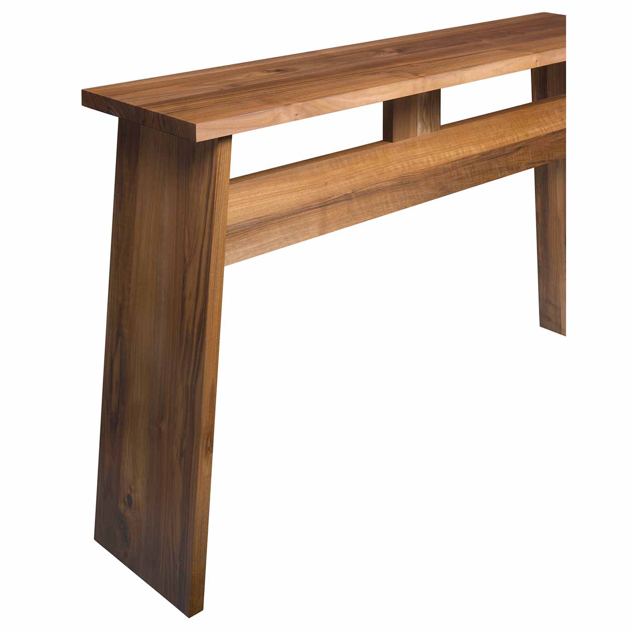 The DC04 DRAYTON by E15 is a minimalist wooden console table with a sleek, modern design. Made from European walnut with a natural finish, it features a flat rectangular top and two wide angled legs, perfect as a stylish sideboard for contemporary spaces.