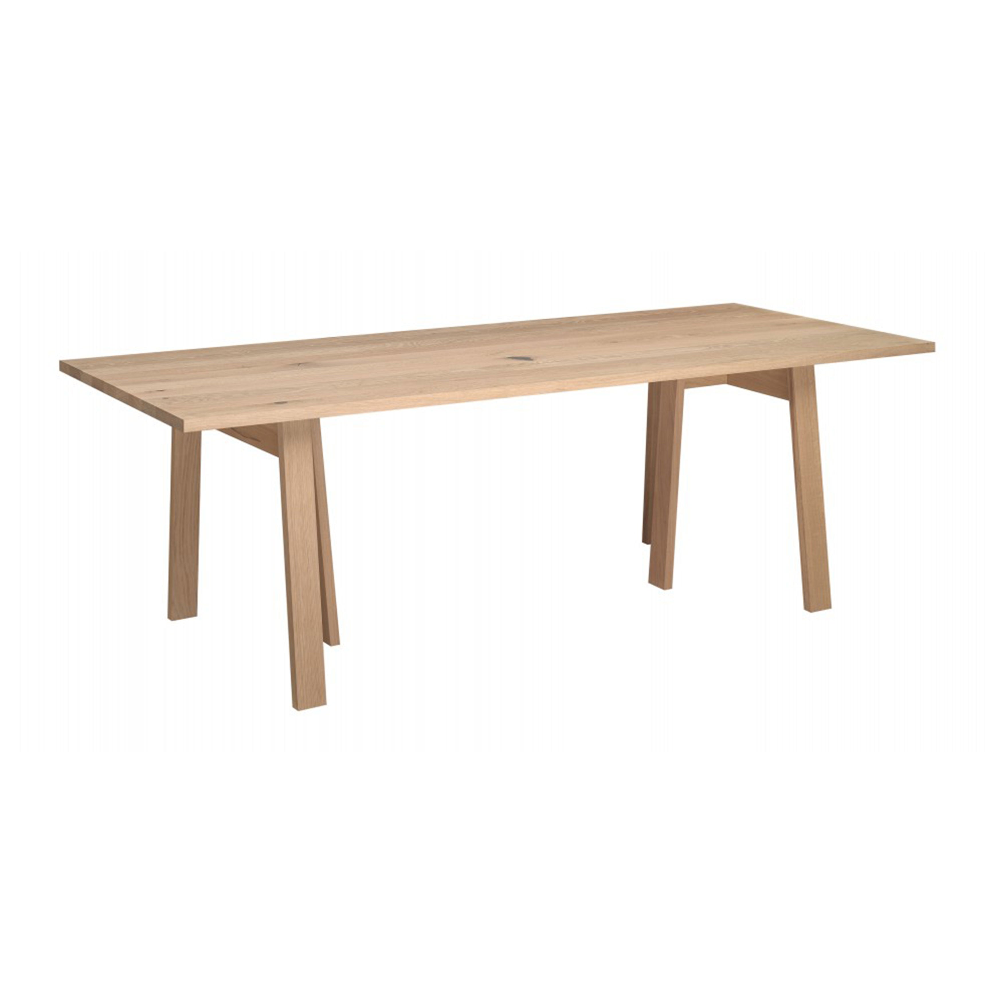 The DC08 Basis Table by E15 features a minimalist design with a light beige finish, solid wood trestles, and four angled legs. Its aesthetic is reminiscent of the classic E15 trestle table style against a plain white background.