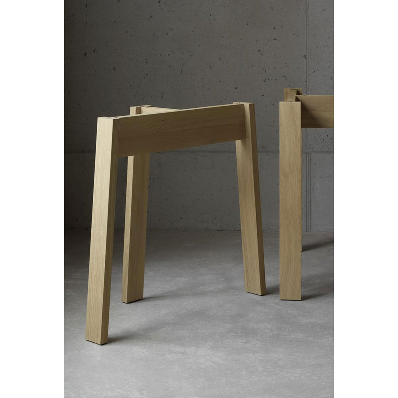 The E15 DC08 Basis Trestle stands on a smooth gray concrete floor against a plain gray wall, highlighting its simplicity and functionality.