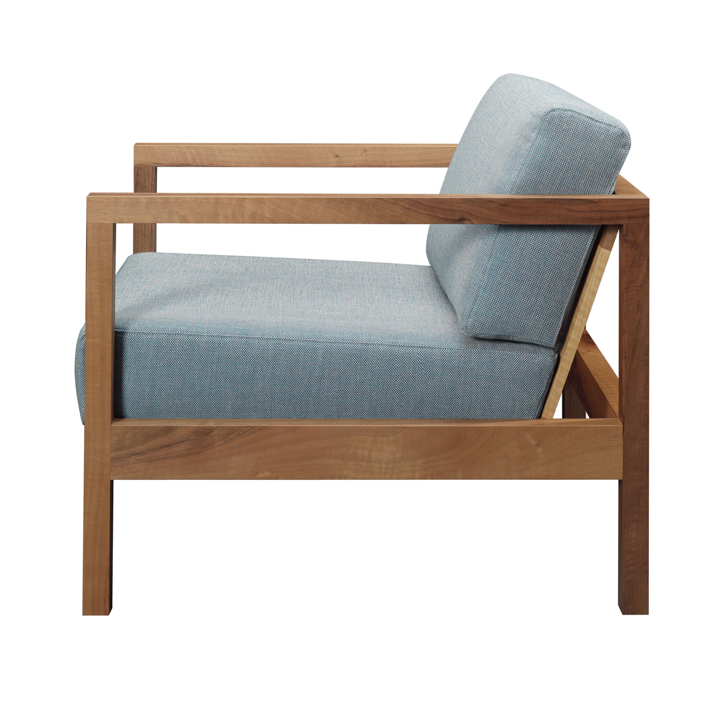 A side view of the EC01 BYRON armchair by E15 highlights its wooden frame with square lines, featuring a light blue fabric on the seat and back cushion. This modern smoking chair combines a minimalist design with comfort.
