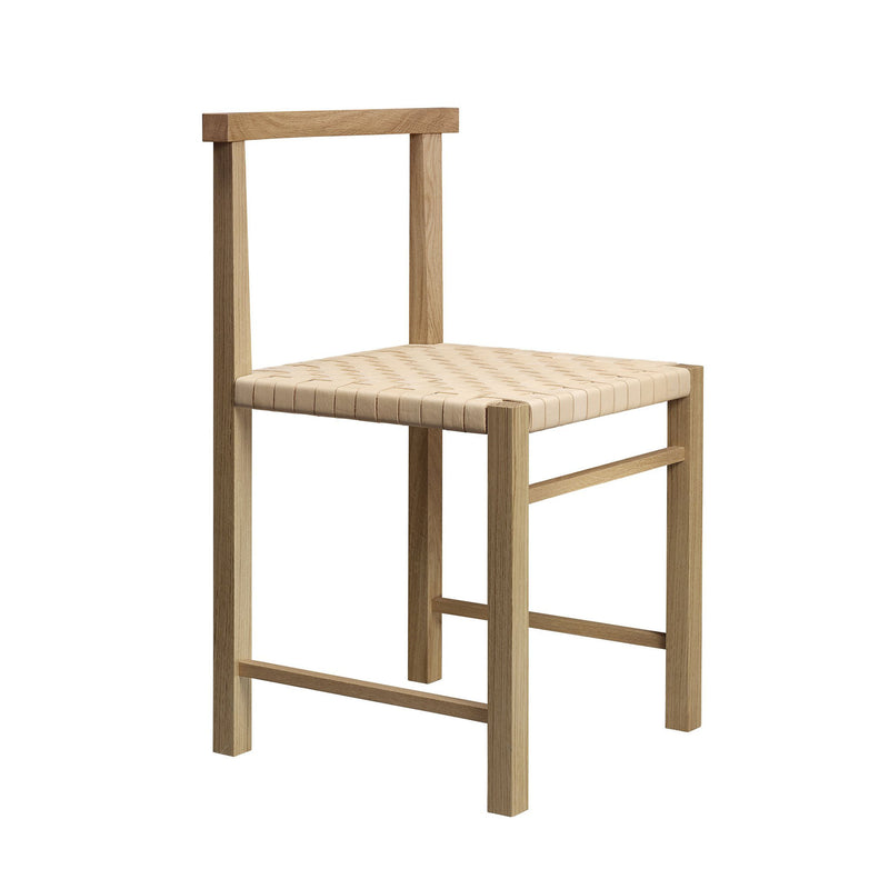 The E15 FK02 KARNAK chair, designed by Ferdinand Kramer, is a minimalist wooden piece with a handwoven light seat, straight backrest, and rectangular frame in a natural finish, showcasing an elegant design.