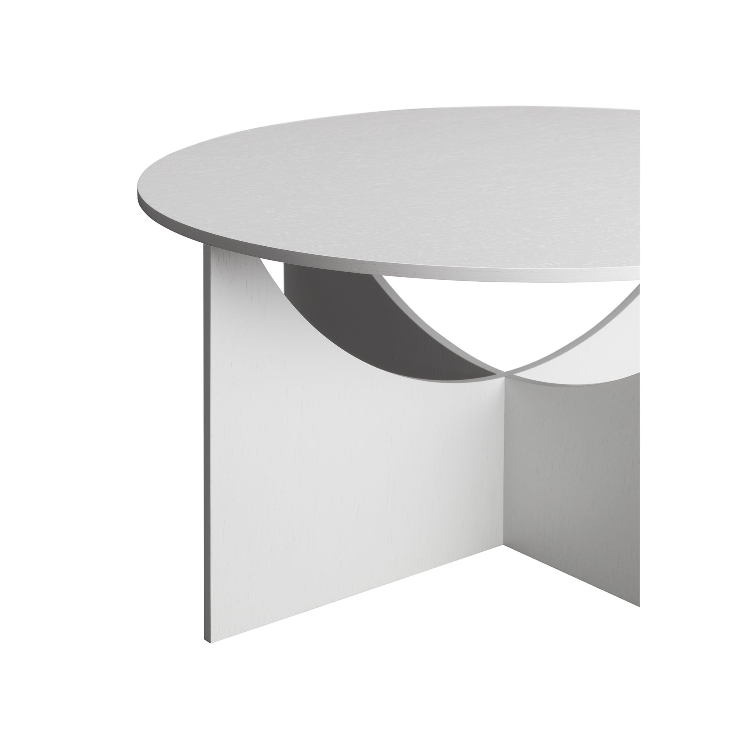 E15s FK05 CHARLOTTE is a modern white circular coffee table, partially visible with a minimalist design. The geometric cutouts on its legs offer a stylish contemporary look against the plain white backdrop, inspired by Ferdinand Kramer.
