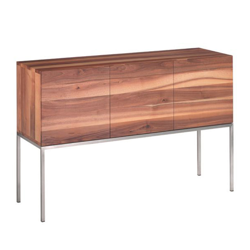The E15 SB02 FARAH is a solid wood sideboard with a minimalist design, boasting a smooth light brown finish. It features three doors and brushed stainless steel legs, exuding an elegant contemporary charm.