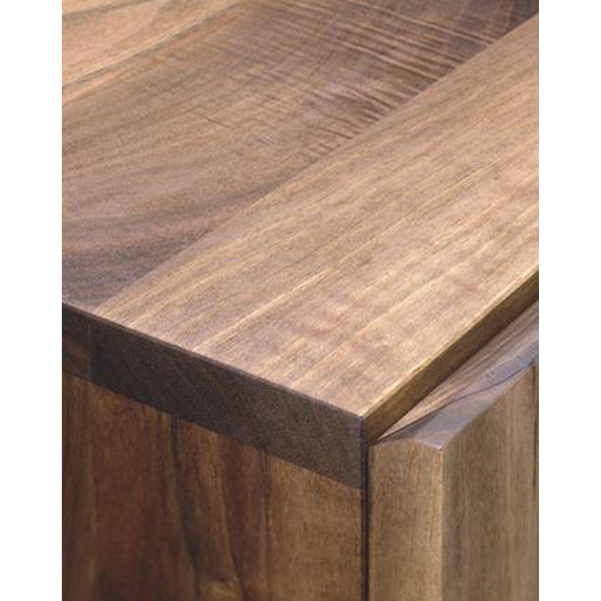 Close-up of the SB03 FARIBA table by E15, showing its smooth, polished surface and natural wood grain. The solid wood table features a rich, warm color with visible texture, emphasizing its craftsmanship and the natural pattern of the wood.