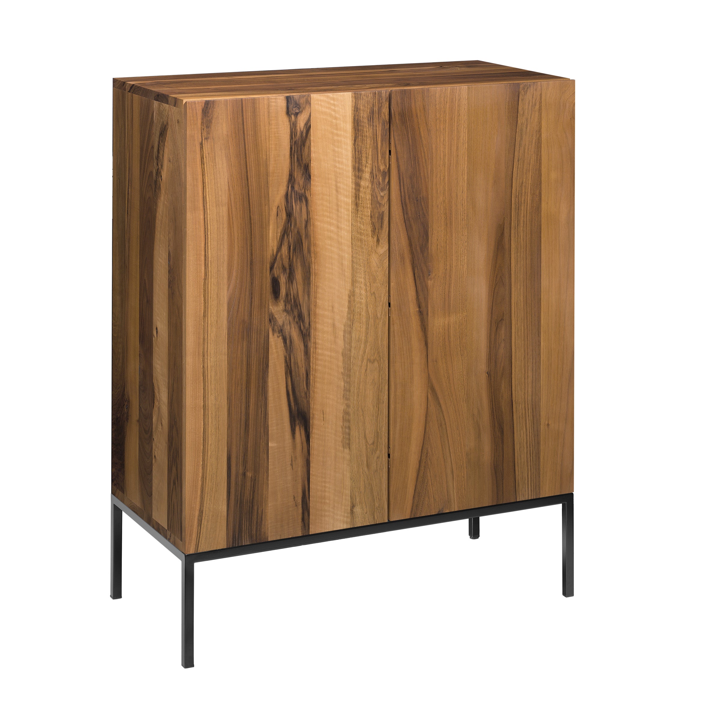 The SB04 FATIMA by E15 is a wooden cabinet with a natural finish and vertical wood grain patterns, crafted from solid wood. It features black metal legs with adjustable feet and maintains a minimalist design.