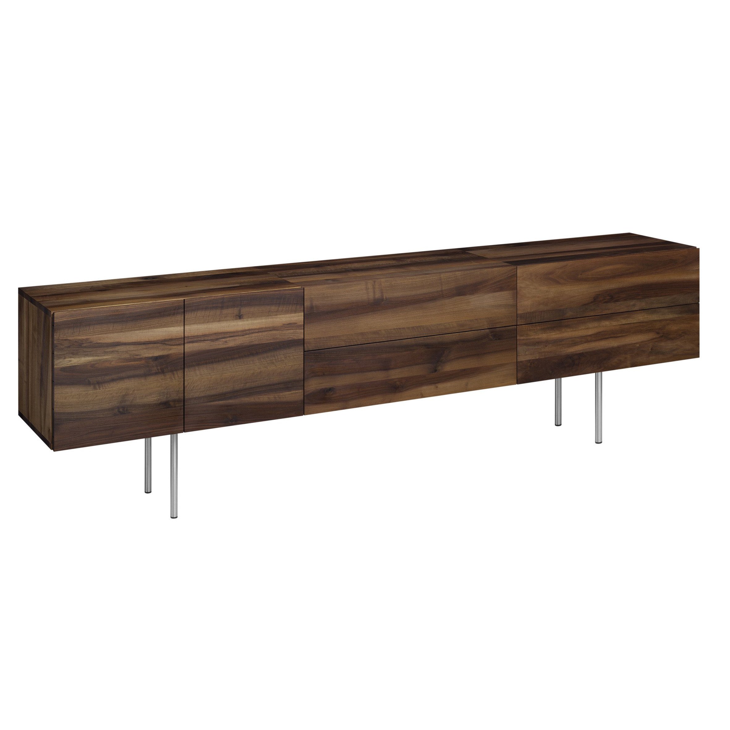 The SB08 MAHNAZ by E15 is a long, rectangular wooden sideboard with a sleek design, featuring a rich walnut finish, three cabinet doors, and elegant handles. It stands on four slender metal legs, showcasing its solid wood body for a modern and minimalist appearance.