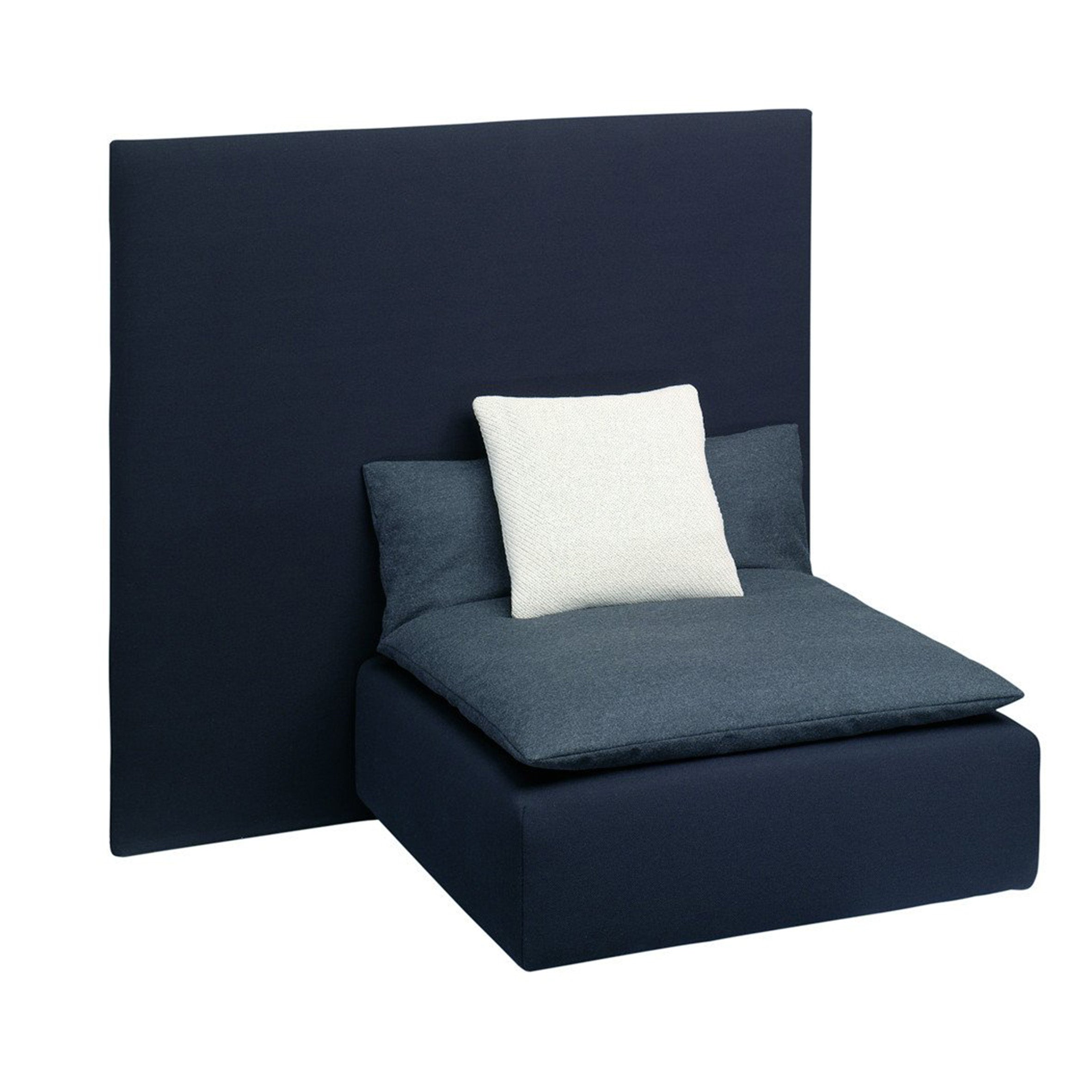 The minimalist SF03 SHIRAZ chair by E15 boasts a modern design with dark upholstery, a high wide backrest, and the elegance of Persian seating islands. It includes light and dark cushions for comfort, all set against a plain white backdrop.