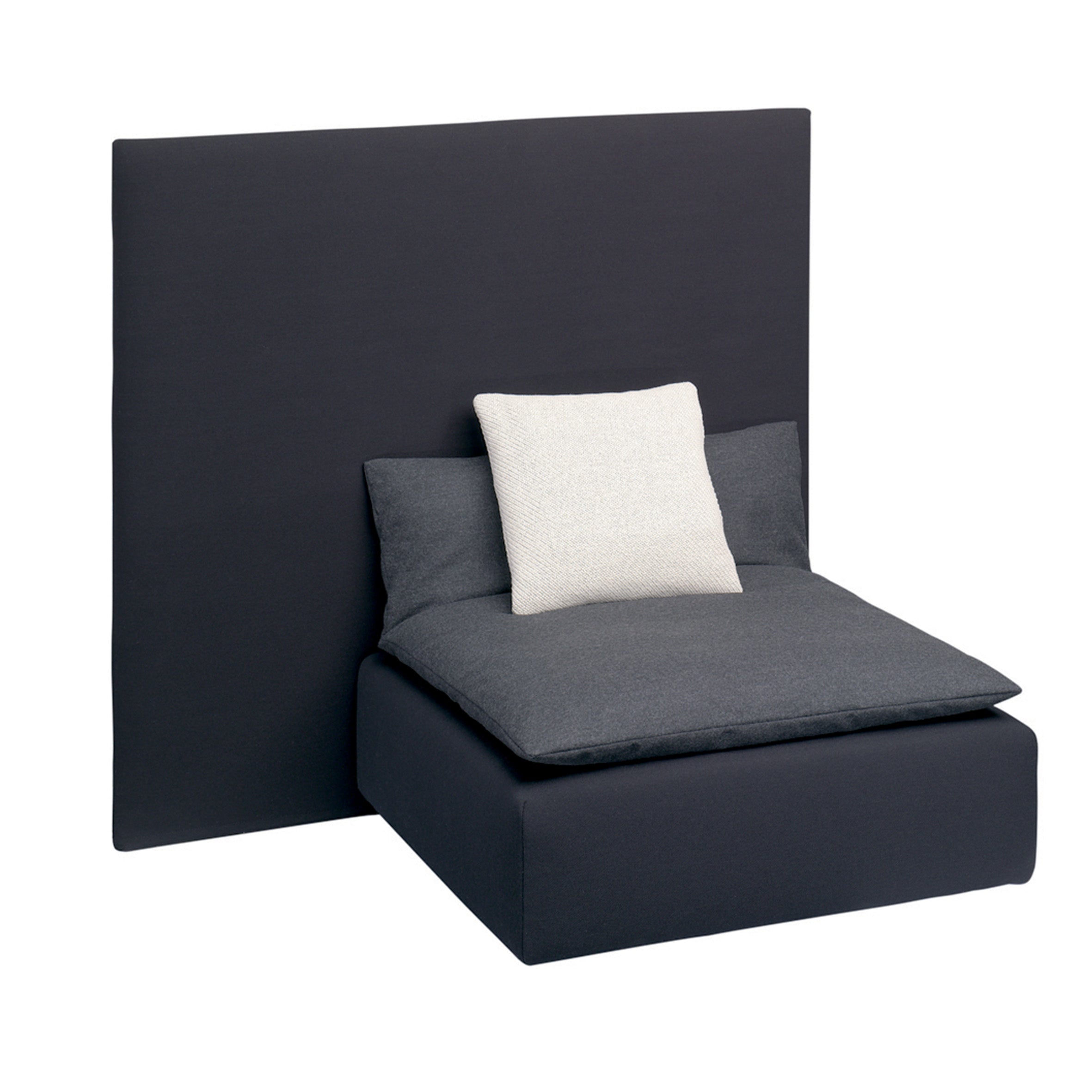 The SF03 SHIRAZ by E15 is a modern black chair with a minimalist design, featuring a large square backrest and oversized seat cushion. A contrasting white decorative pillow enhances its sophisticated elegance against the plain white backdrop.